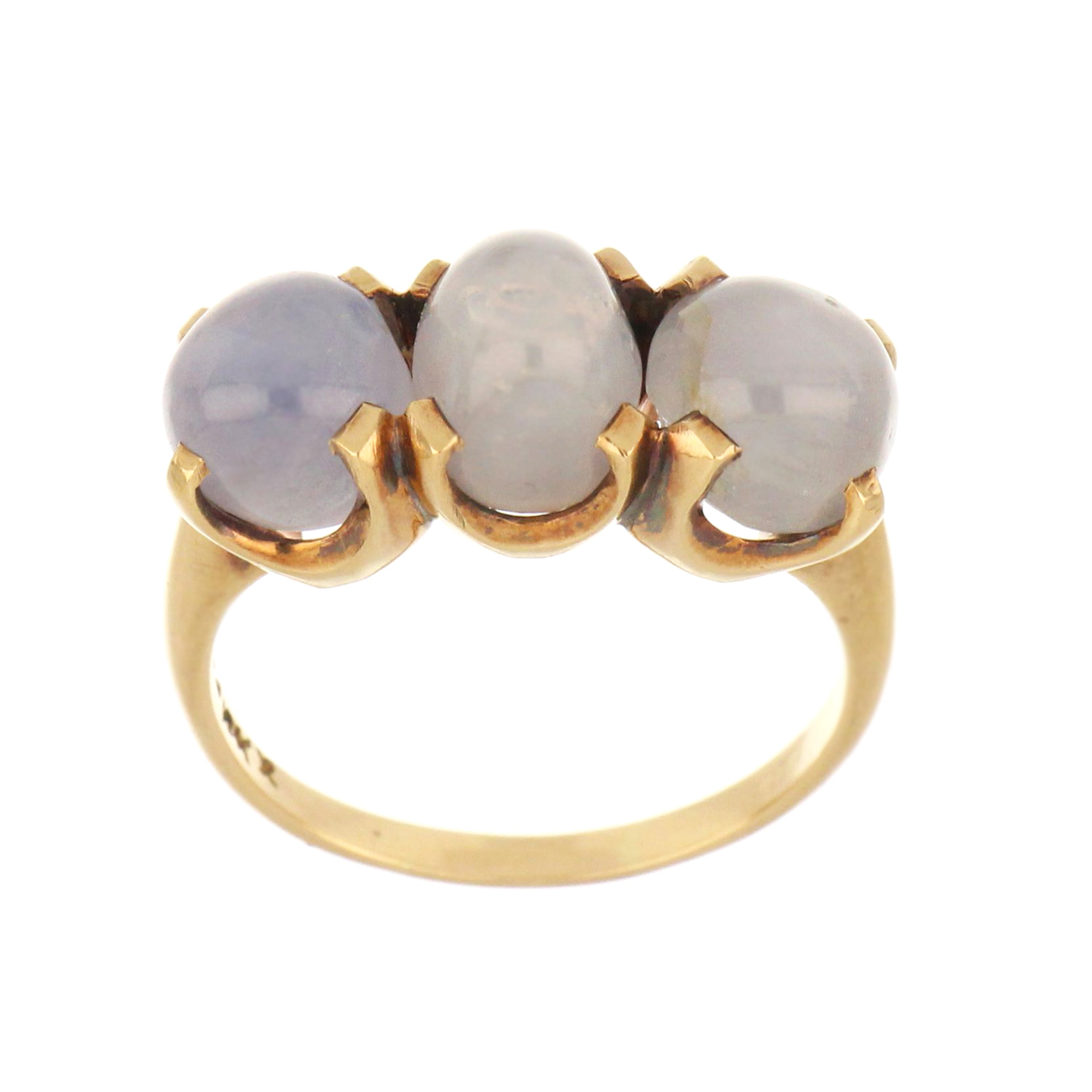 Three-stone 10kt yellow gold ring with oval blue star sapphires in cabochon cut.