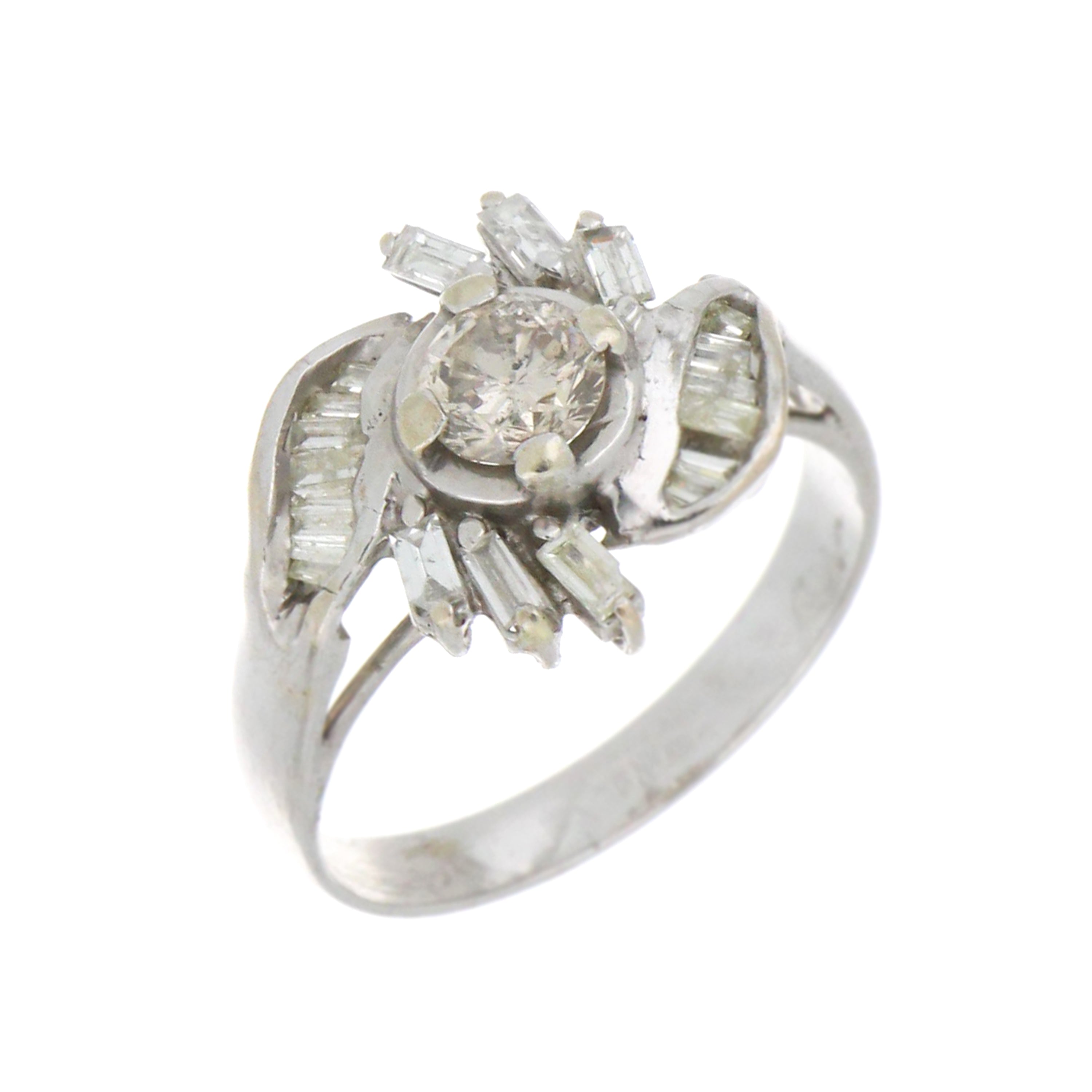 Close-up of 12kt white gold ring showing round and baguette diamond setting