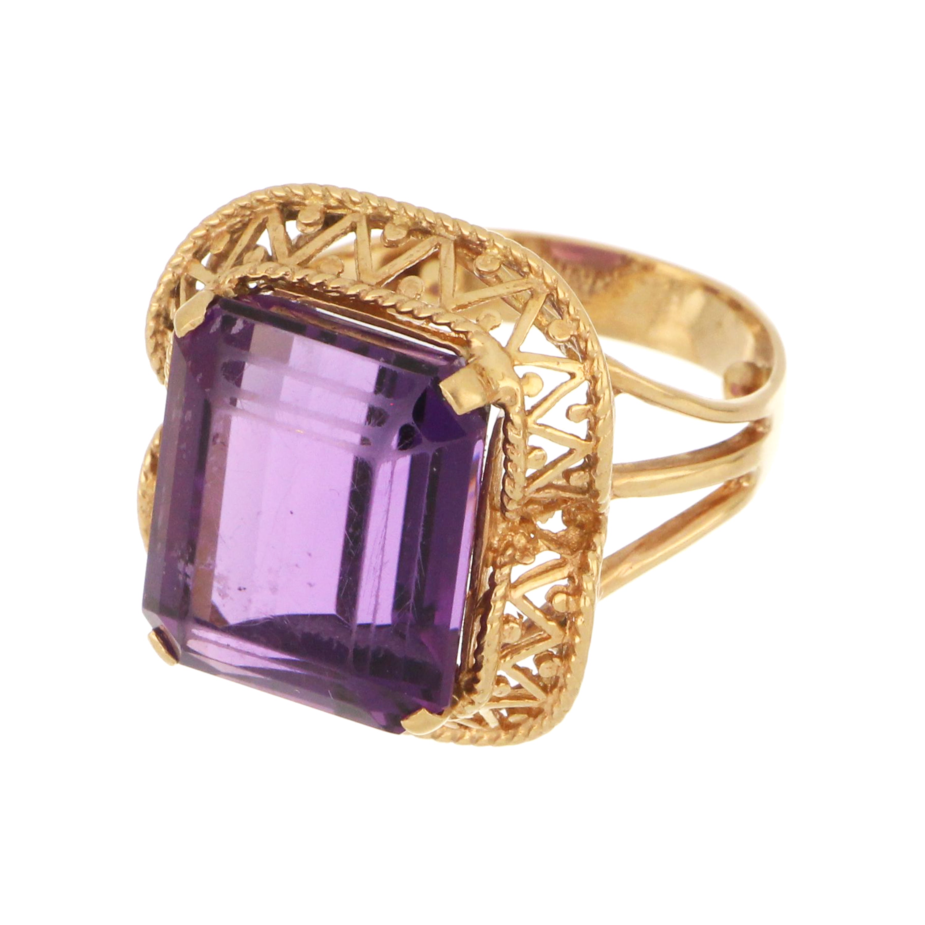 Statement dinner ring in 14kt gold with deep purple emerald-cut amethyst.