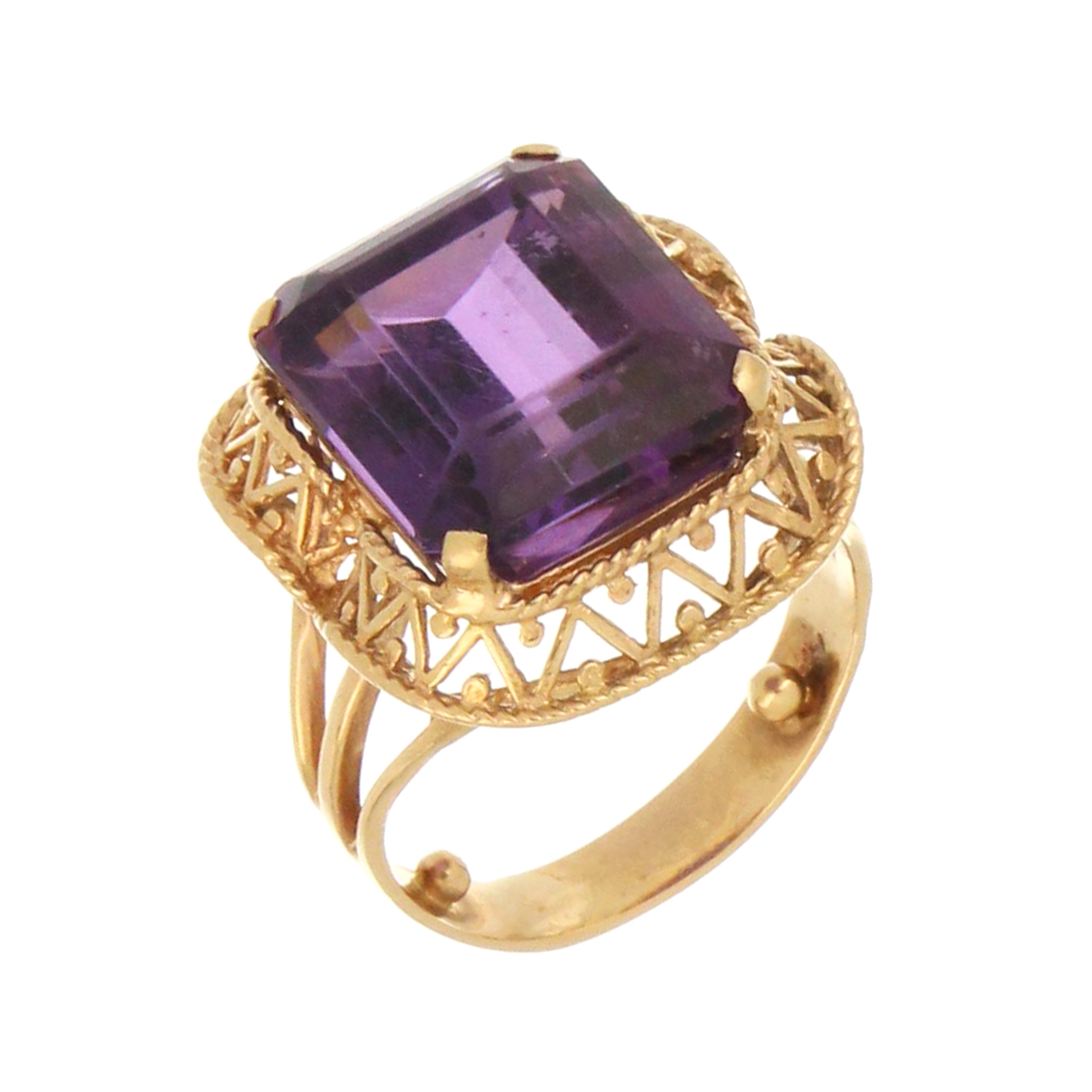 Vintage-style gold amethyst ring featuring bold rectangular gemstone and intricate lattice design.