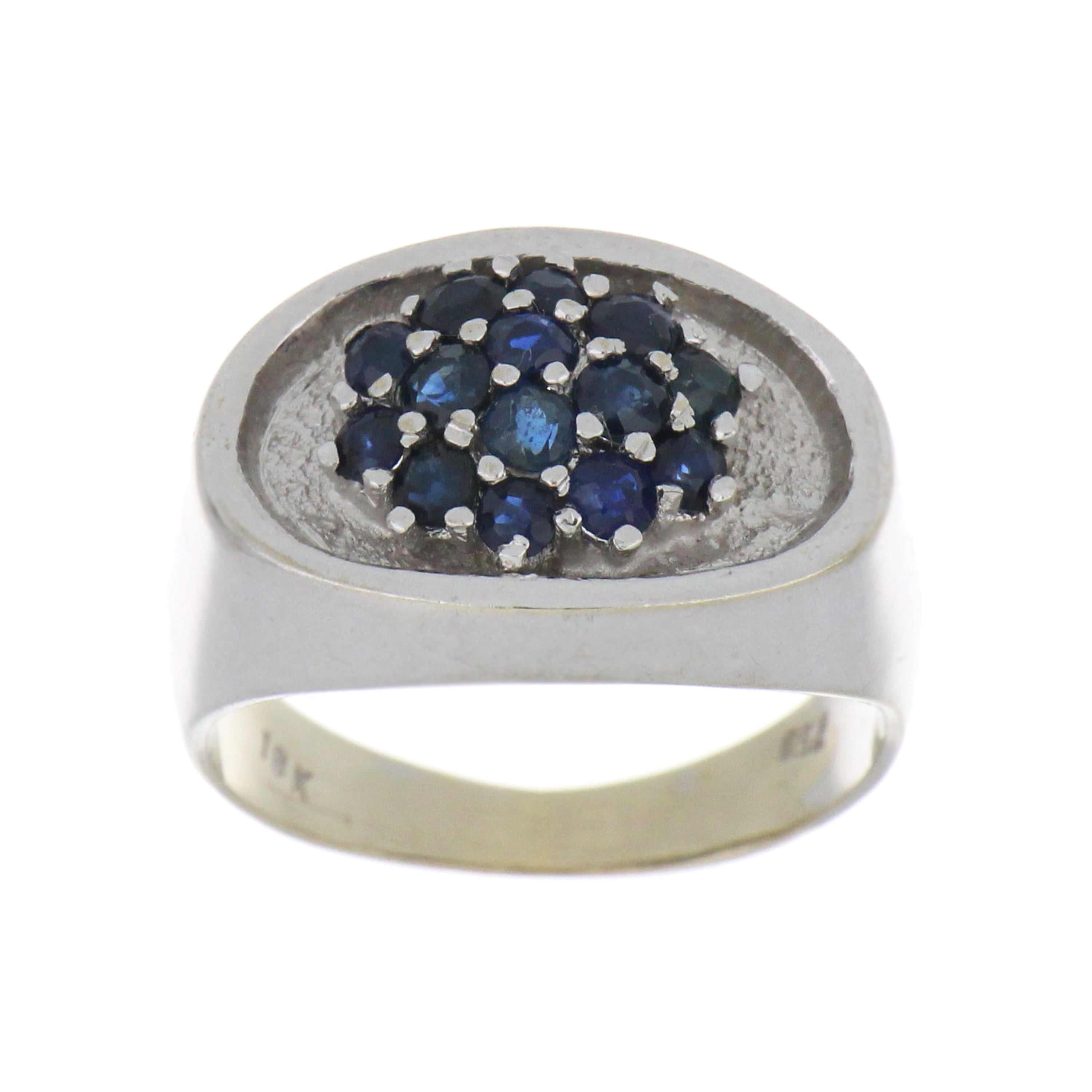 18kt white gold ring featuring 14 round blue sapphires in a clustered oval design, size 6.5.