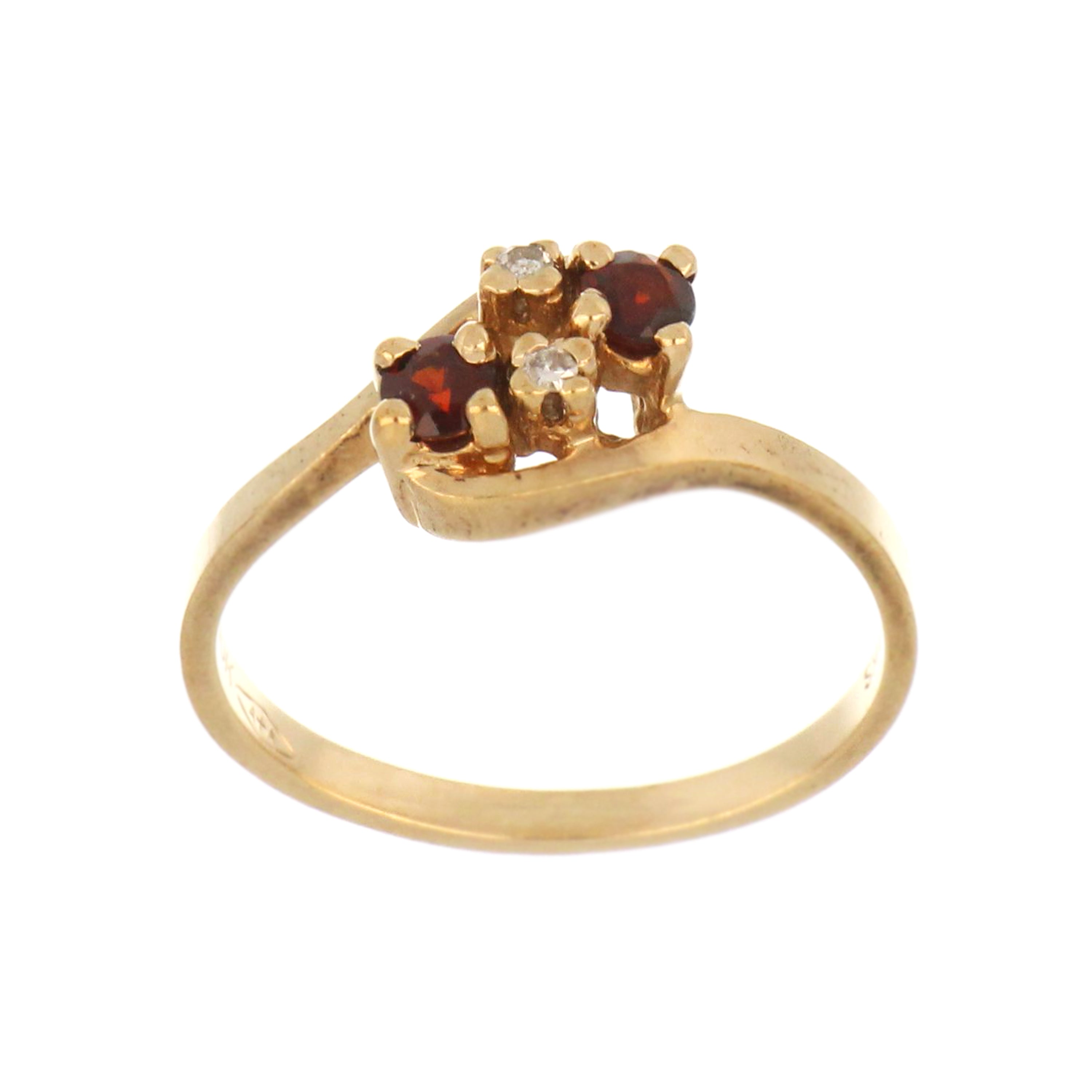 10kt yellow gold ring with two round red garnets and two small single cut diamonds, top angle showing setting and stone brilliance