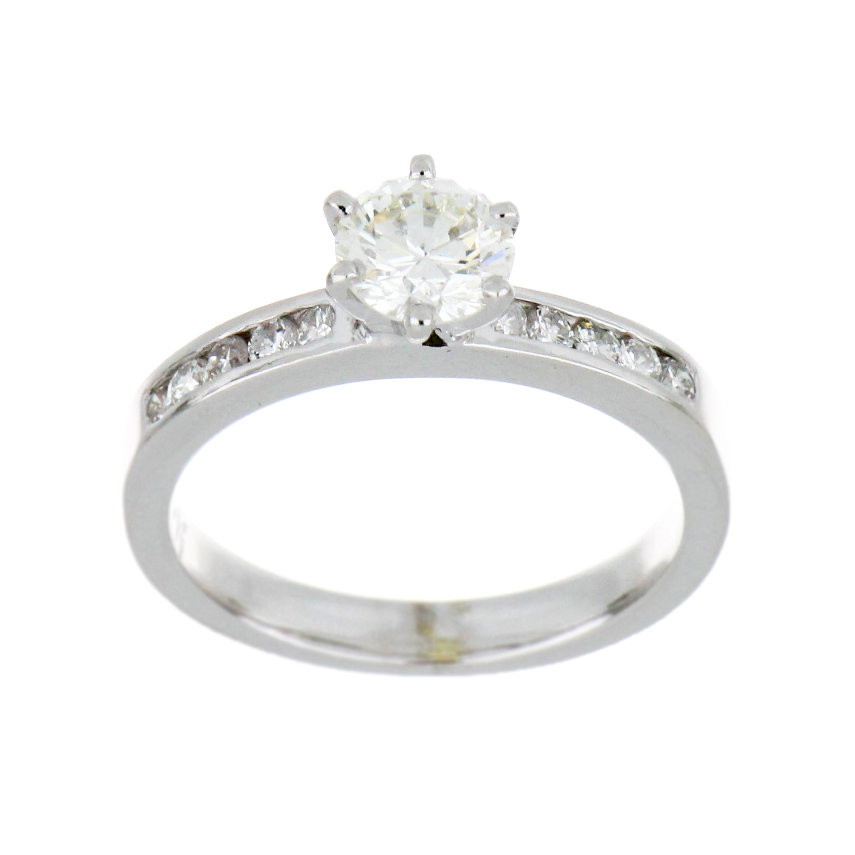 Close-up of 19kt white gold ring featuring a 0.74ct round brilliant cut diamond with six-claw setting and channel-set small round diamonds