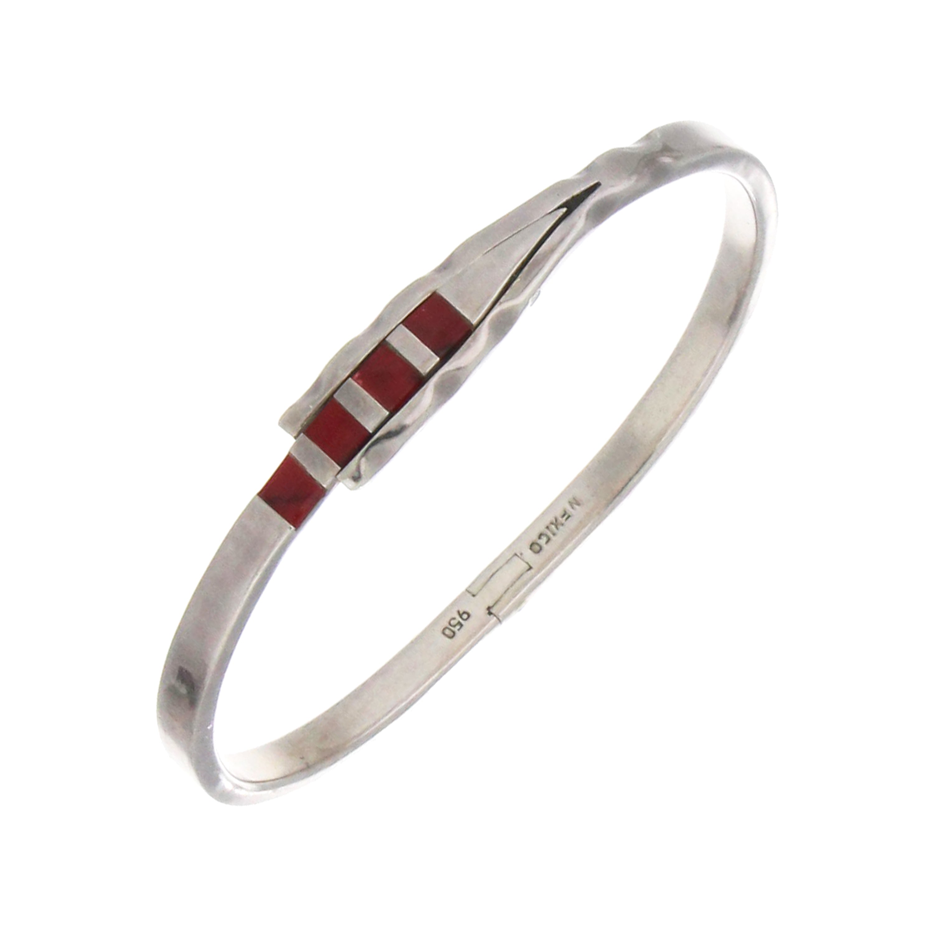 Sterling silver bangle set with four red stones, top view showing shiny polished surface and stone settings
