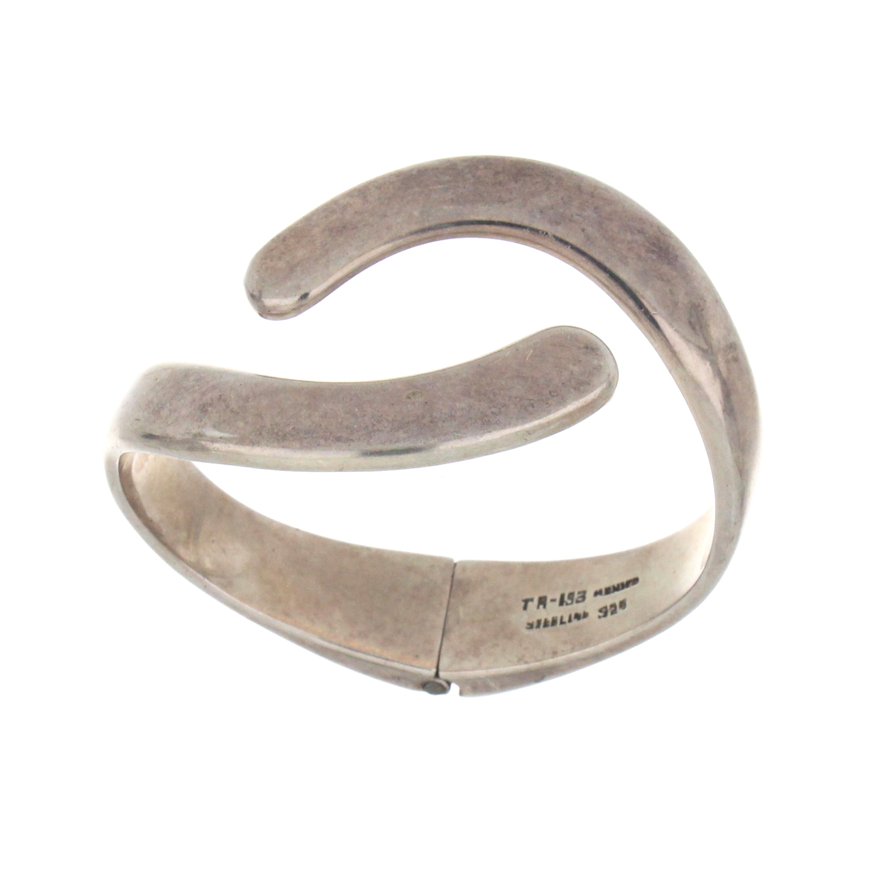 Sterling silver bangle with open-end design, showcased from an angled top view, weighing approximately 66 grams