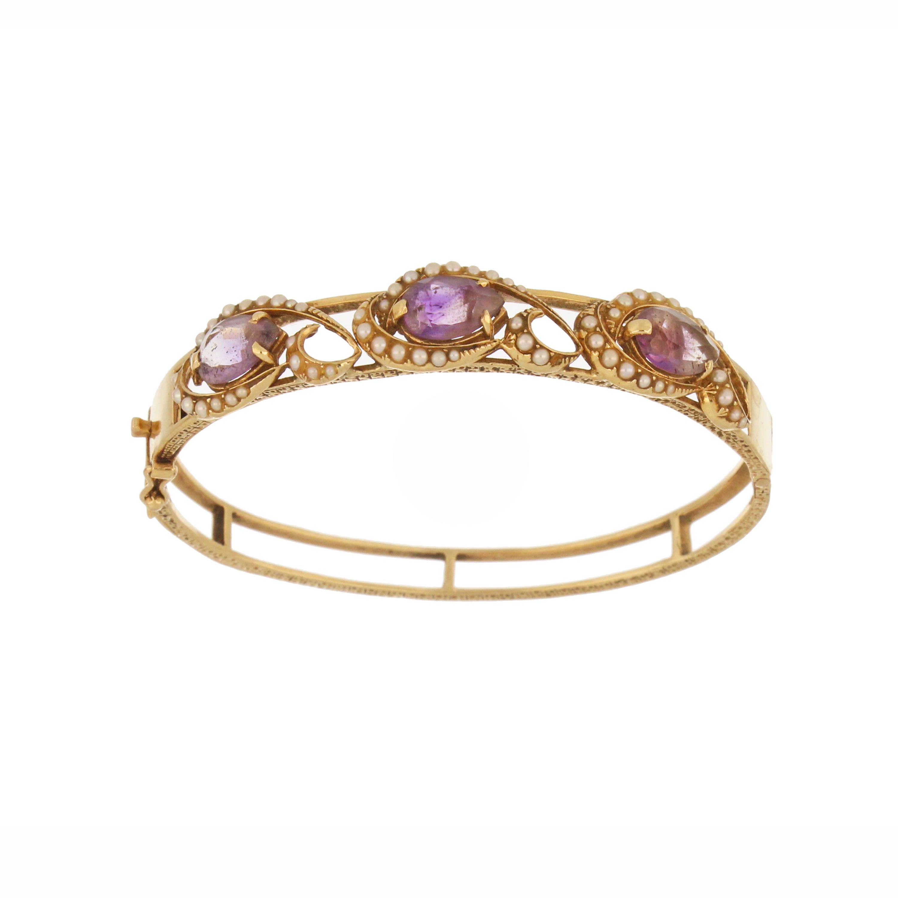 Close-up detail of 14kt yellow gold amethyst bangle showing pear-shaped stones and seed pearl accents, side profile