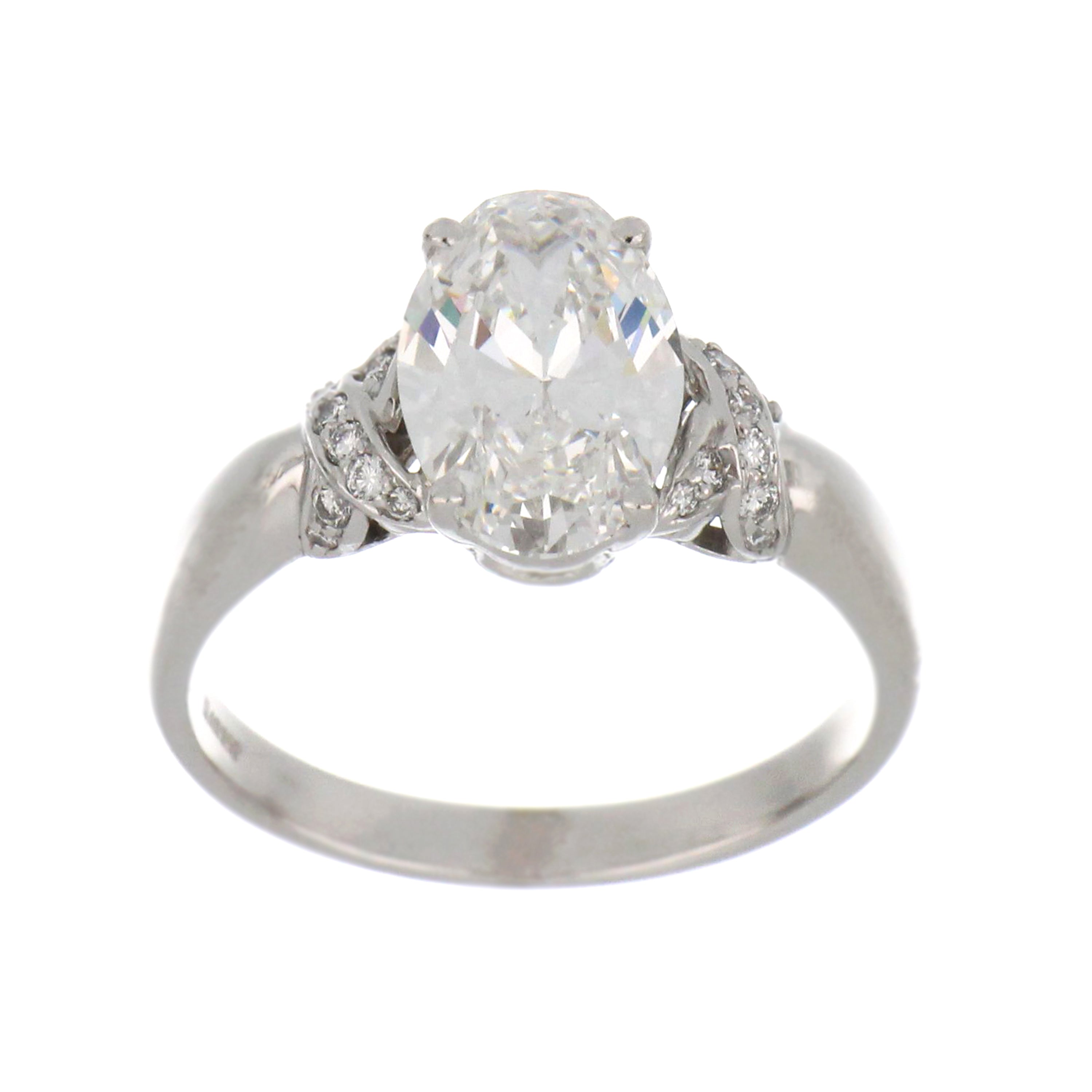 Polished 18kt white gold engagement ring displaying oval diamond with high clarity and color