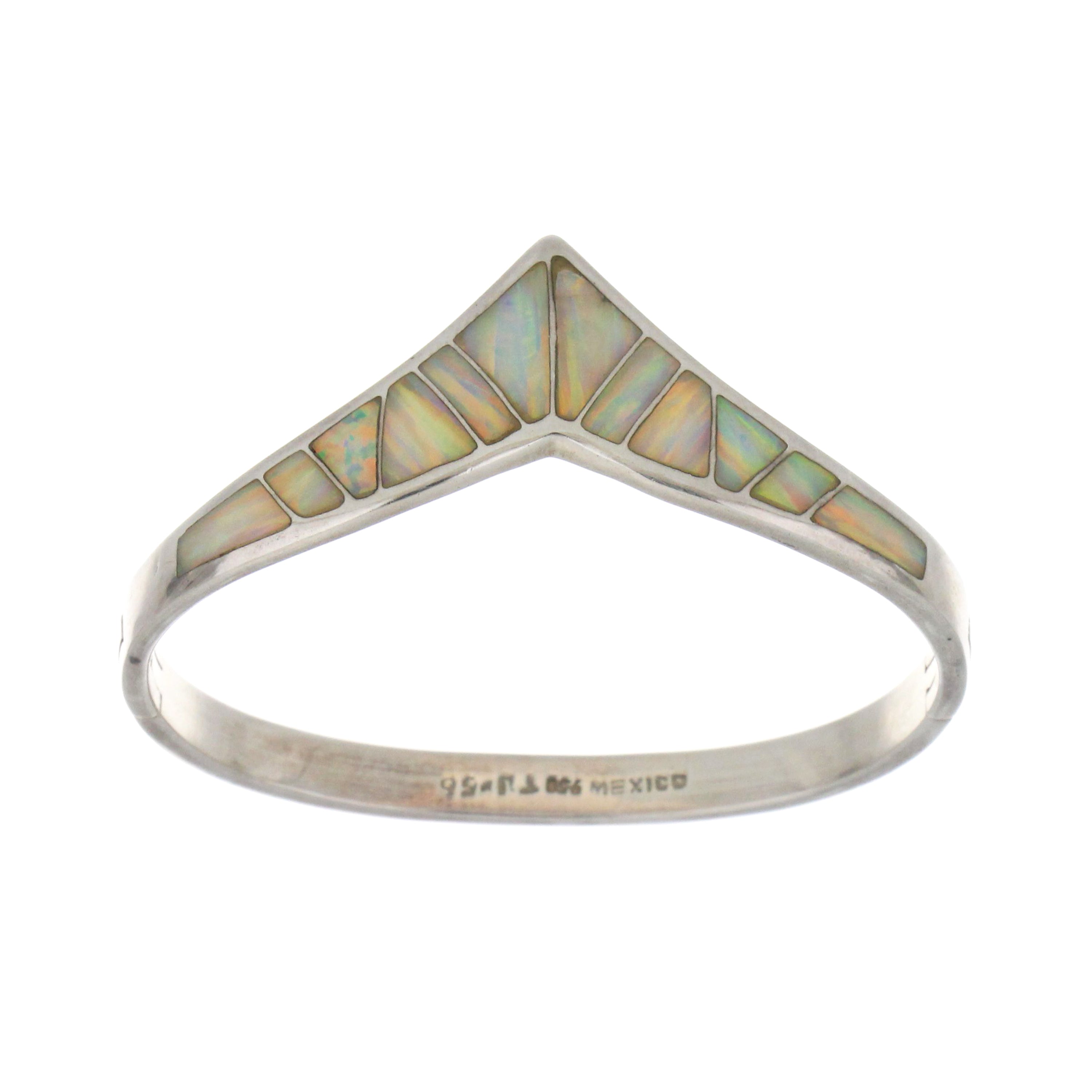 Close-up of sterling silver bangle featuring luminous white opals, showcasing polished finish and smooth rounded edges