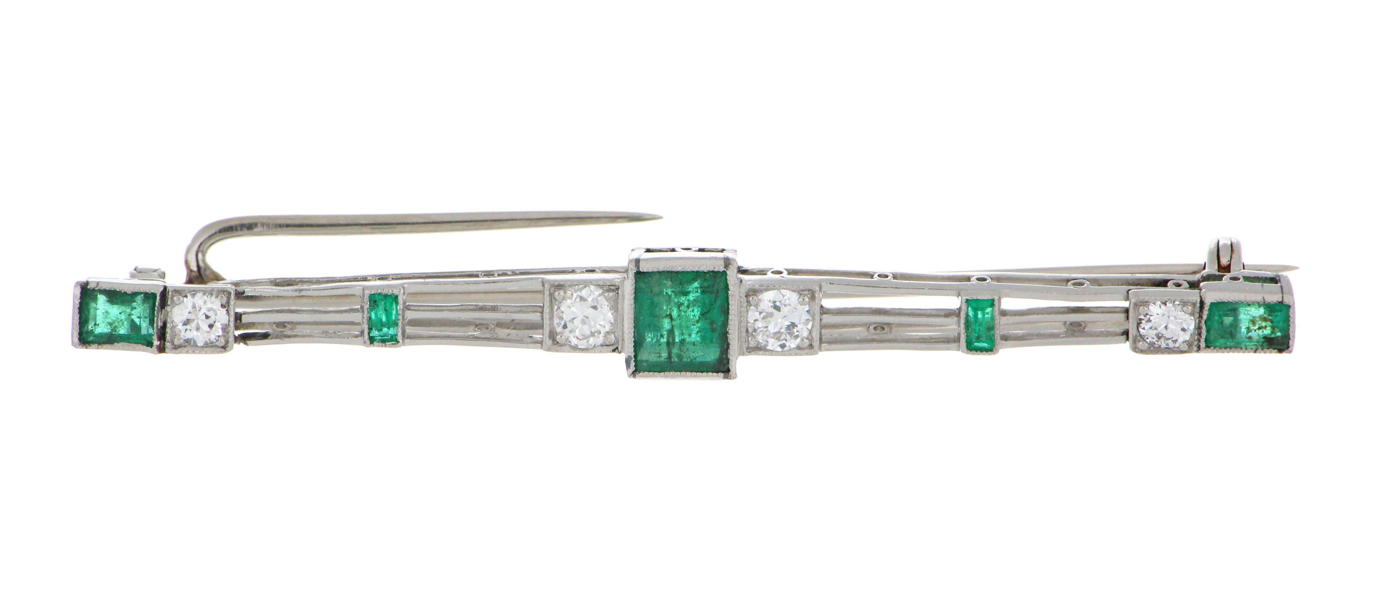 Platinum brooch featuring old European cut diamonds and baguette-cut emeralds, angled view showcasing 4.26 grams total weight