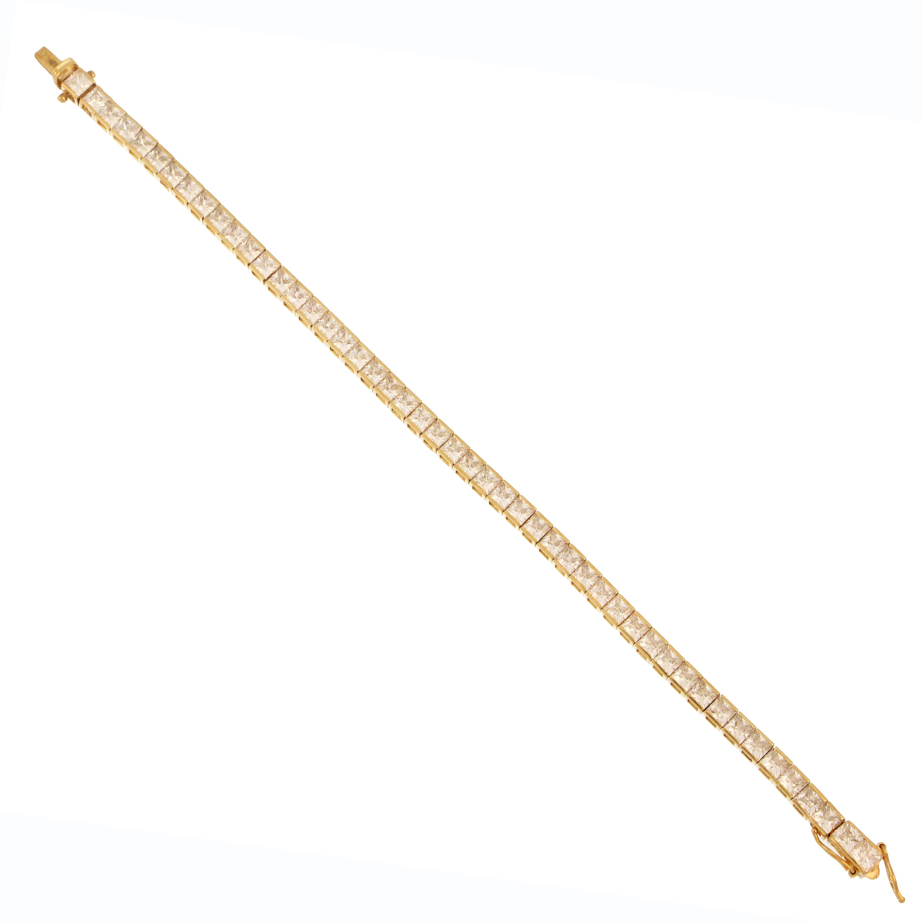 14kt yellow gold tennis bracelet close-up showing square shaped step cut cubic zirconia stones and clasp detail