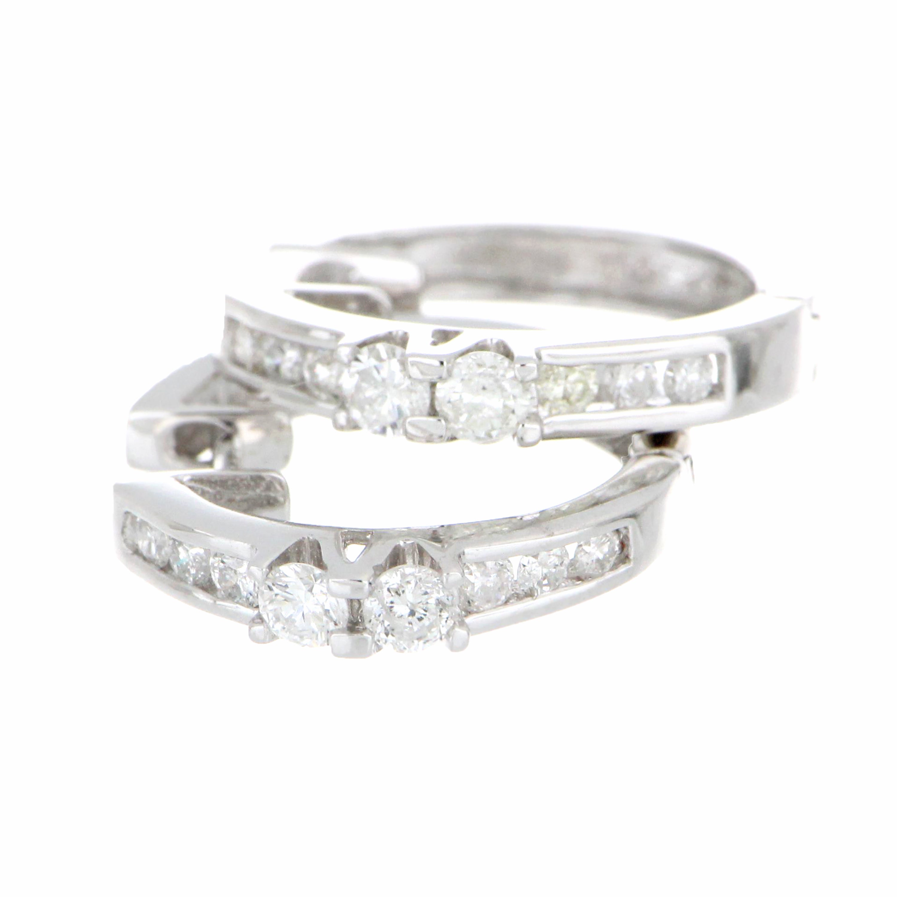 Detailed angle of 18kt white gold diamond hoop earring highlighting sparkling round diamonds and smooth hoop design