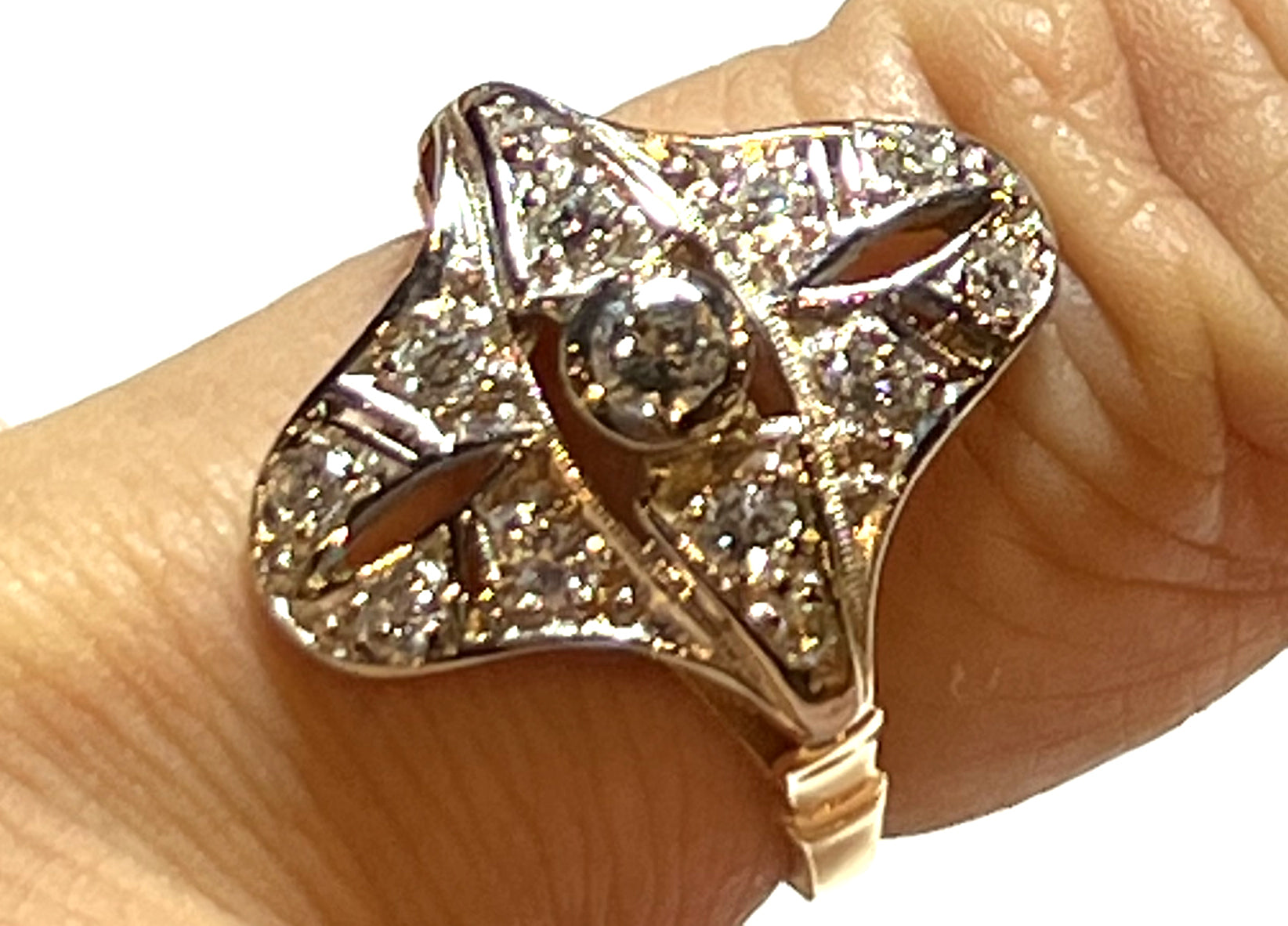 side angle of 18kt yellow gold antique ring showcasing 12 smaller diamonds in white gold setting with vintage design detail