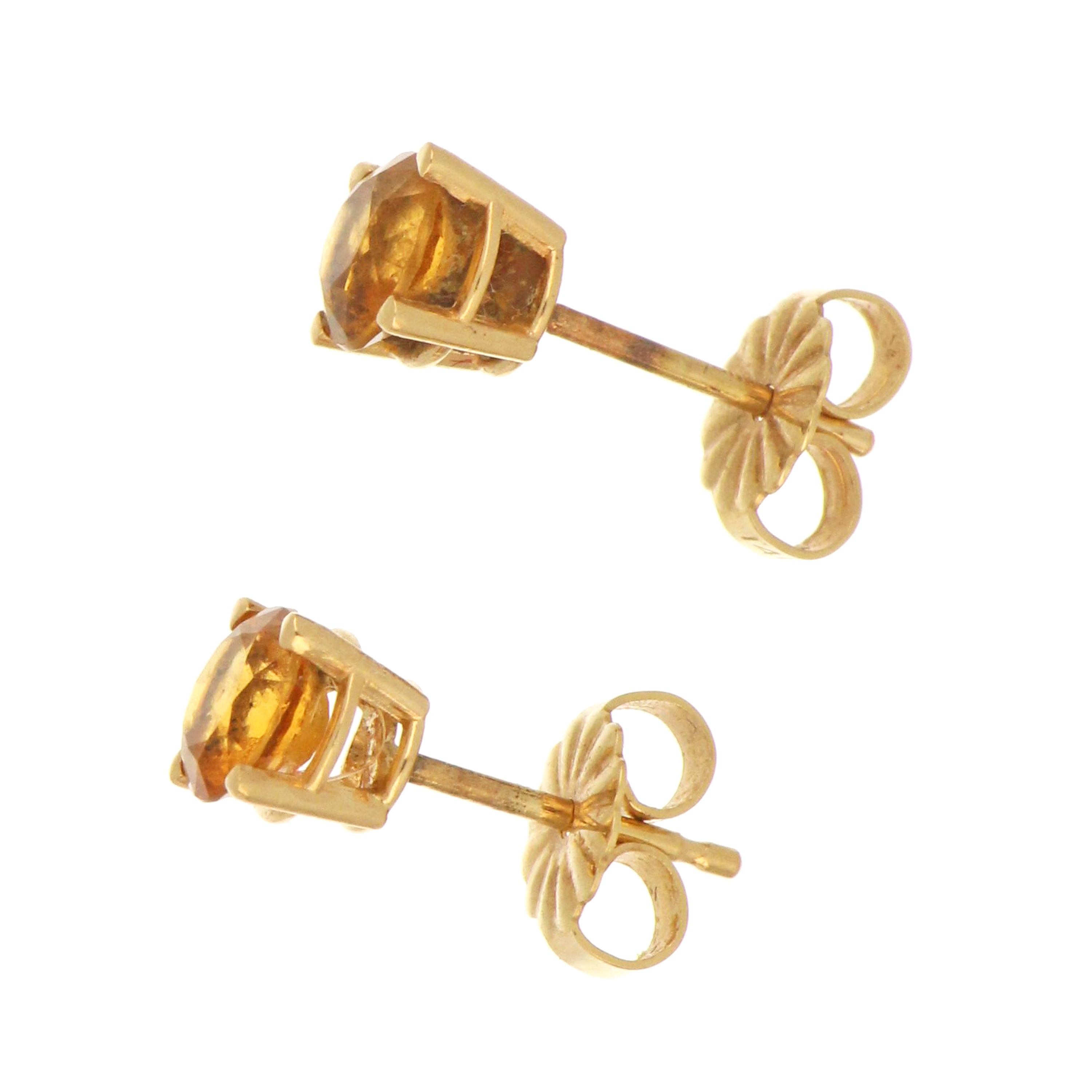 Pair of 14kt yellow gold stud earrings with round citrine stones, side angle highlighting polished gold setting and gemstone clarity