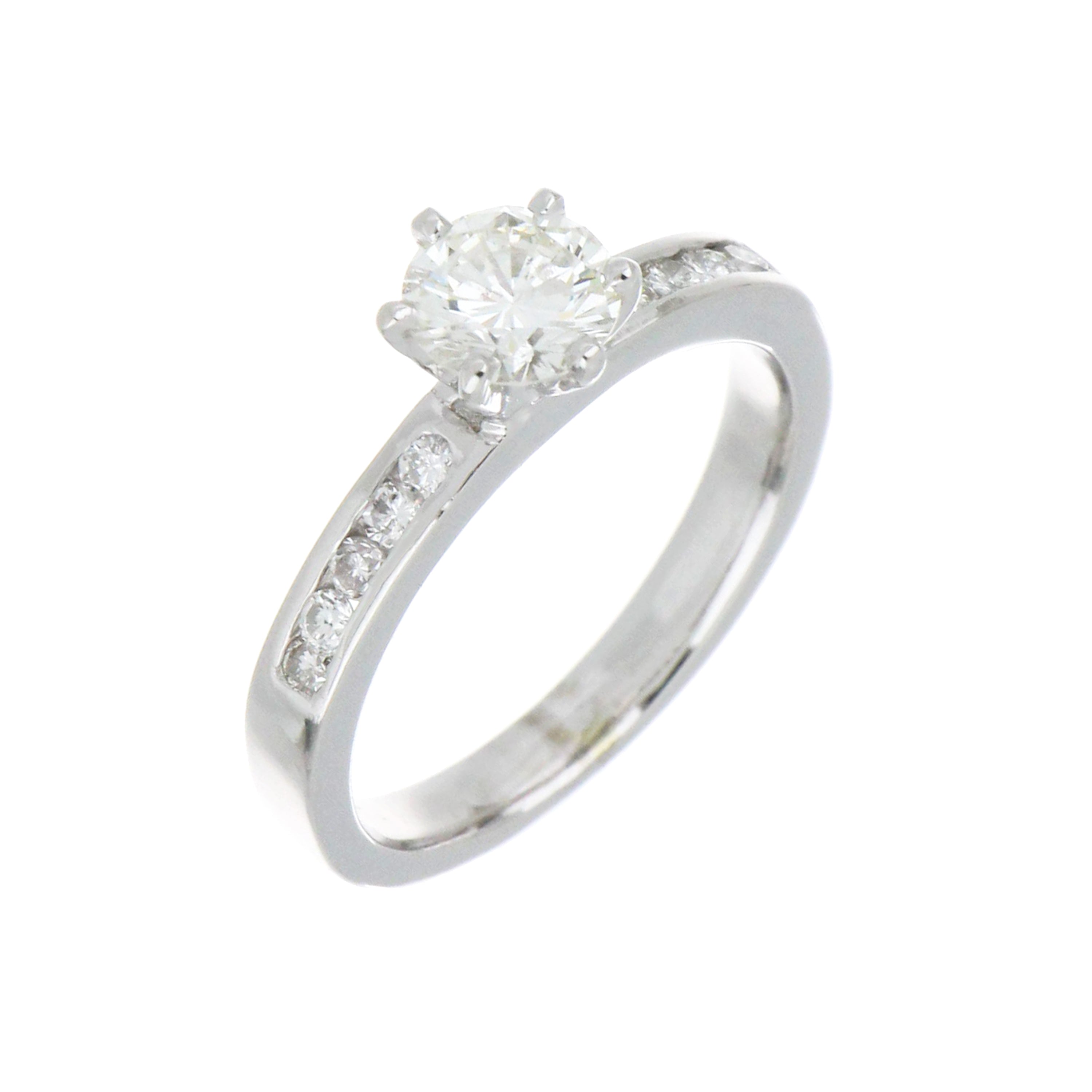 Side angle view of 19kt white gold diamond ring highlighting the polished shank and channel-set round side diamonds