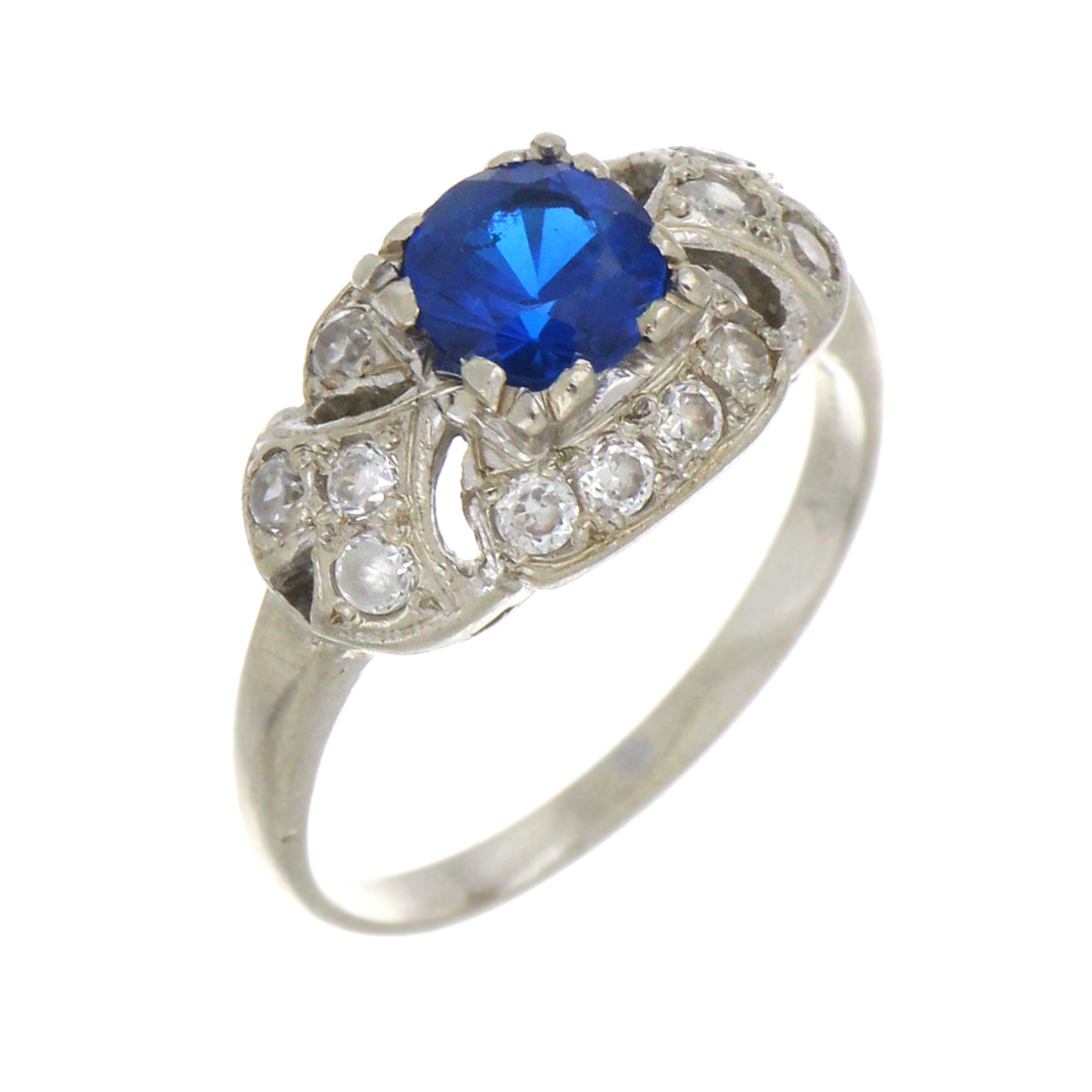 Side angle of 14kt white gold blue cubic zirconia ring, highlighting polished band and stone setting