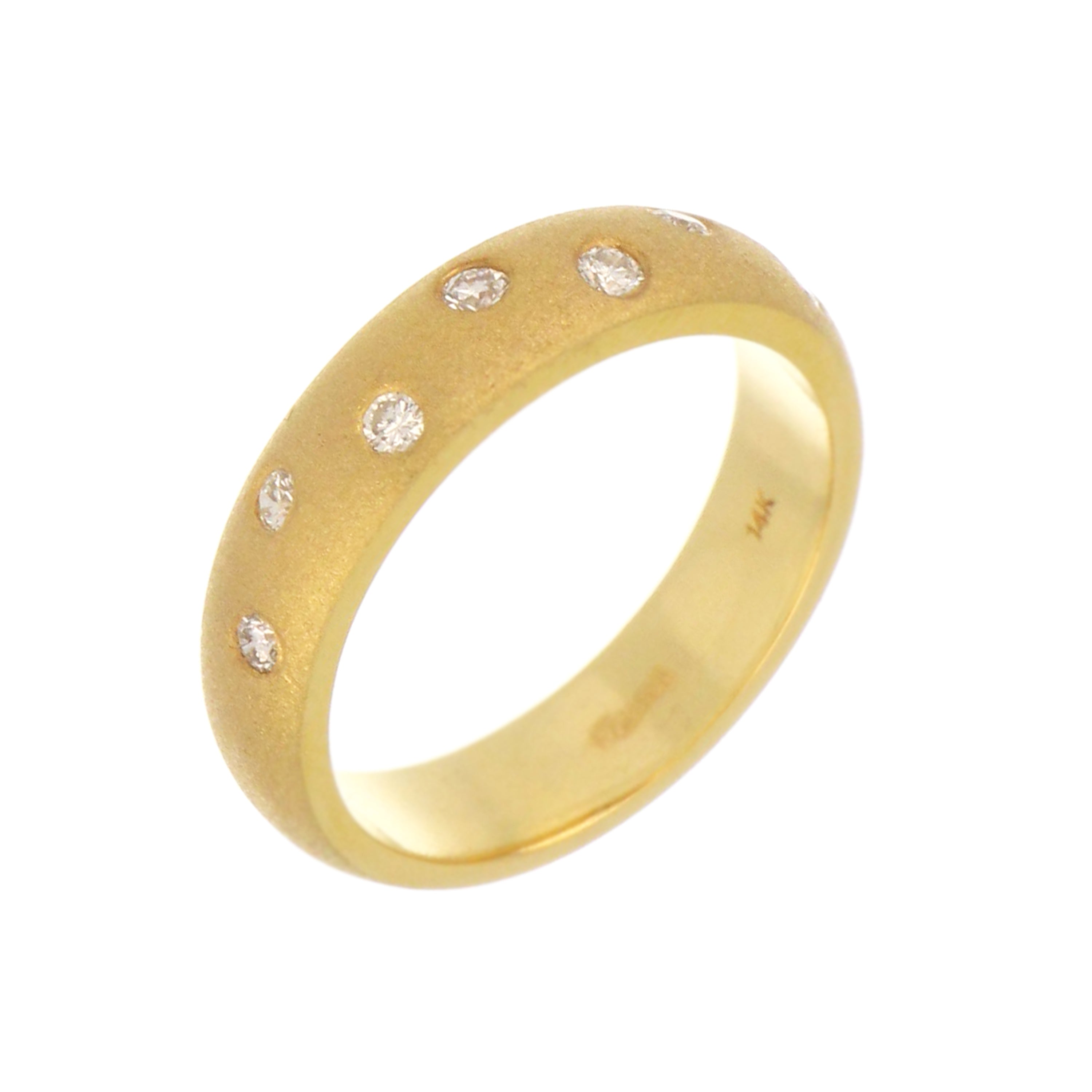 Side profile of 14kt yellow gold diamond band highlighting gypsy diamond setting and smooth design