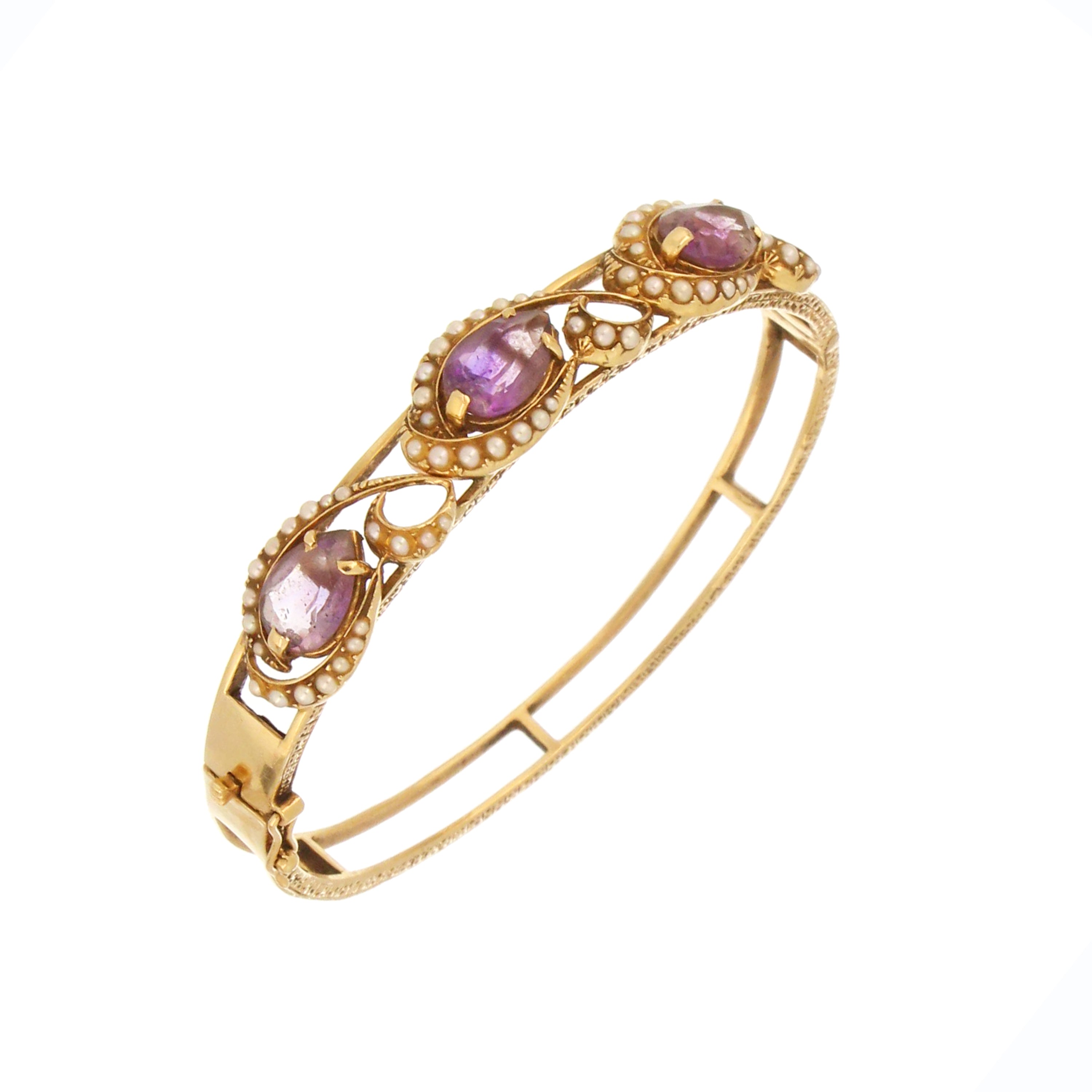 14kt yellow gold bangle featuring three pear-shaped amethysts each approximately 10.5x7.0 mm, accented with delicate seed pearls, front angle view