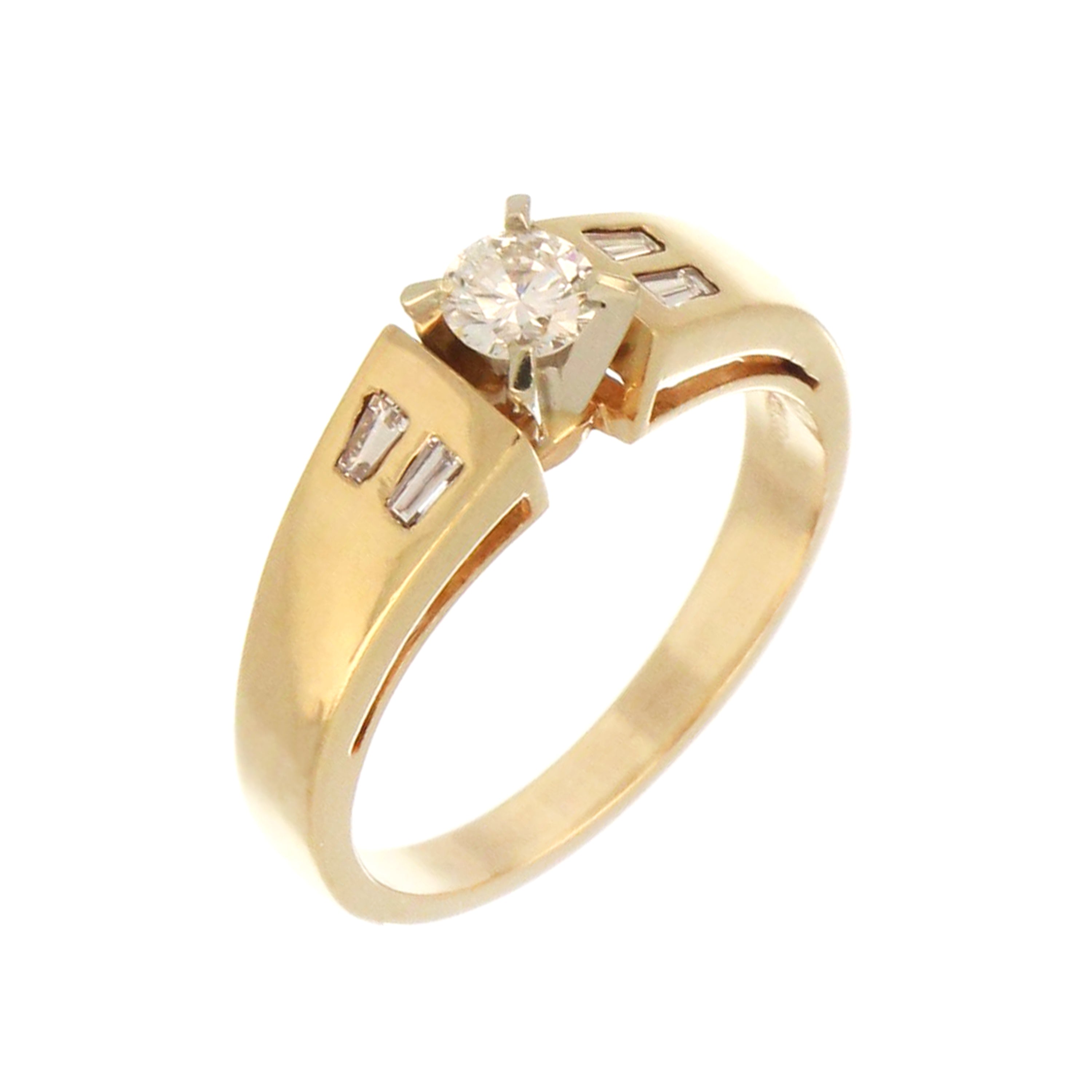 Top view of 14kt yellow gold diamond ring showcasing claw and gypsy settings on round and baguette diamonds
