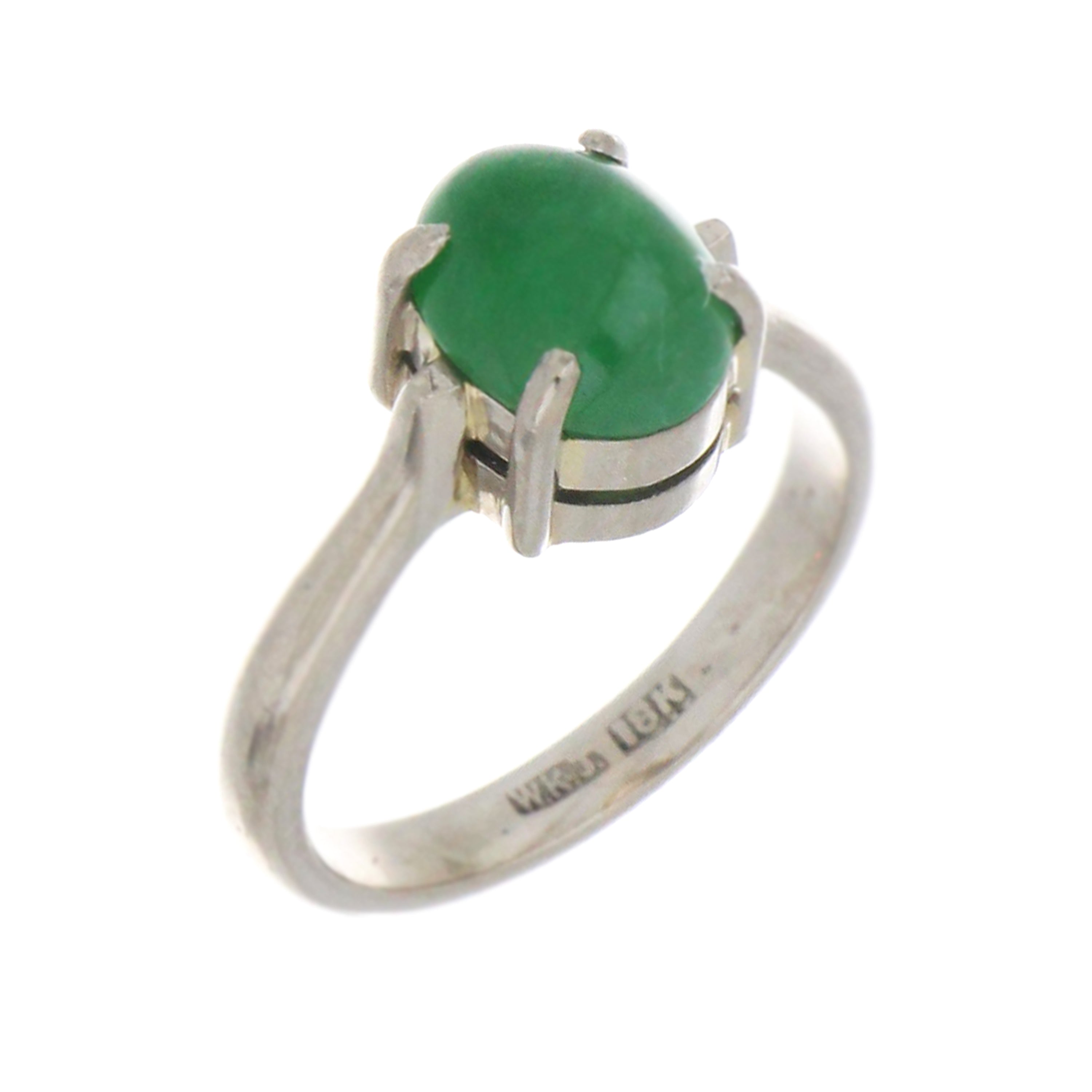 Close-up of oval cabochon natural jadeite jade stone mounted in 4-claw setting on 18kt white gold ring
