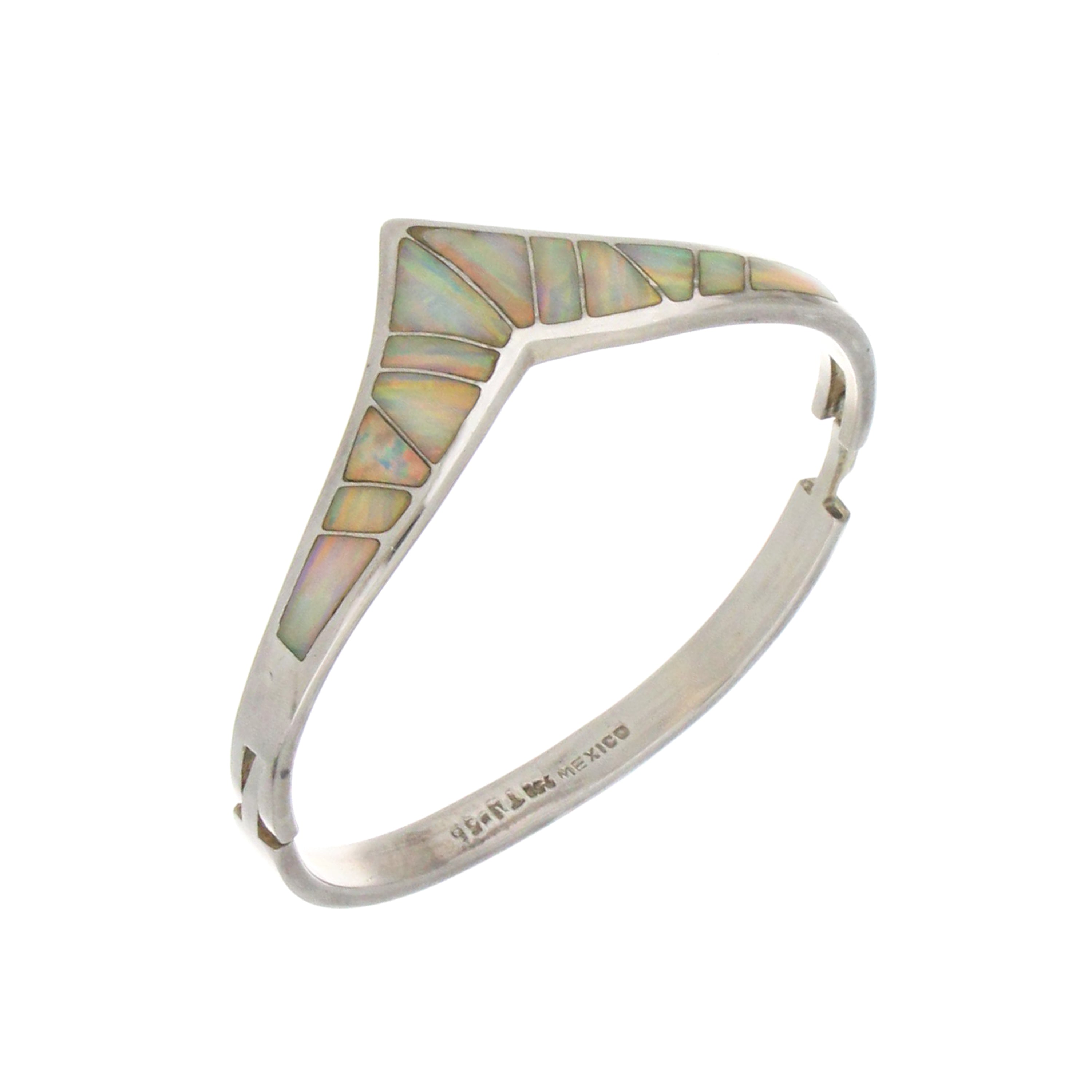 Pair of sterling silver bangles with white opals arranged side by side, highlighting opal iridescence and silver craftsmanship