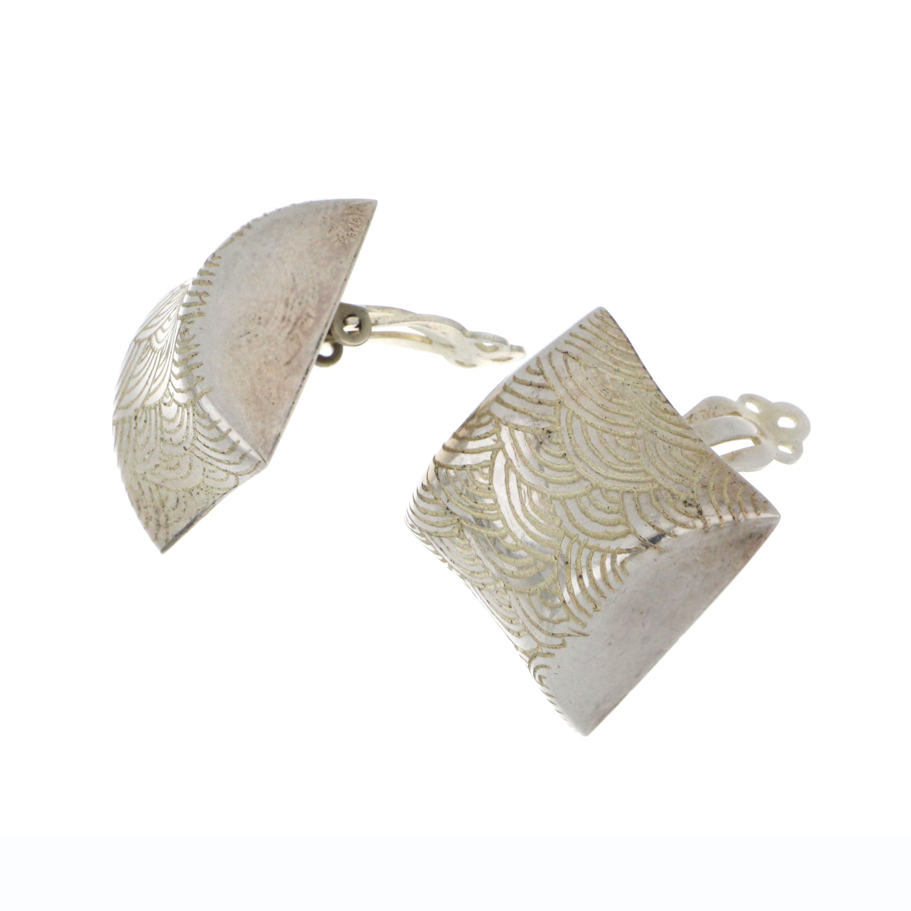 Close-up side view of sterling silver button earring showcasing ocean wave design and smooth finish