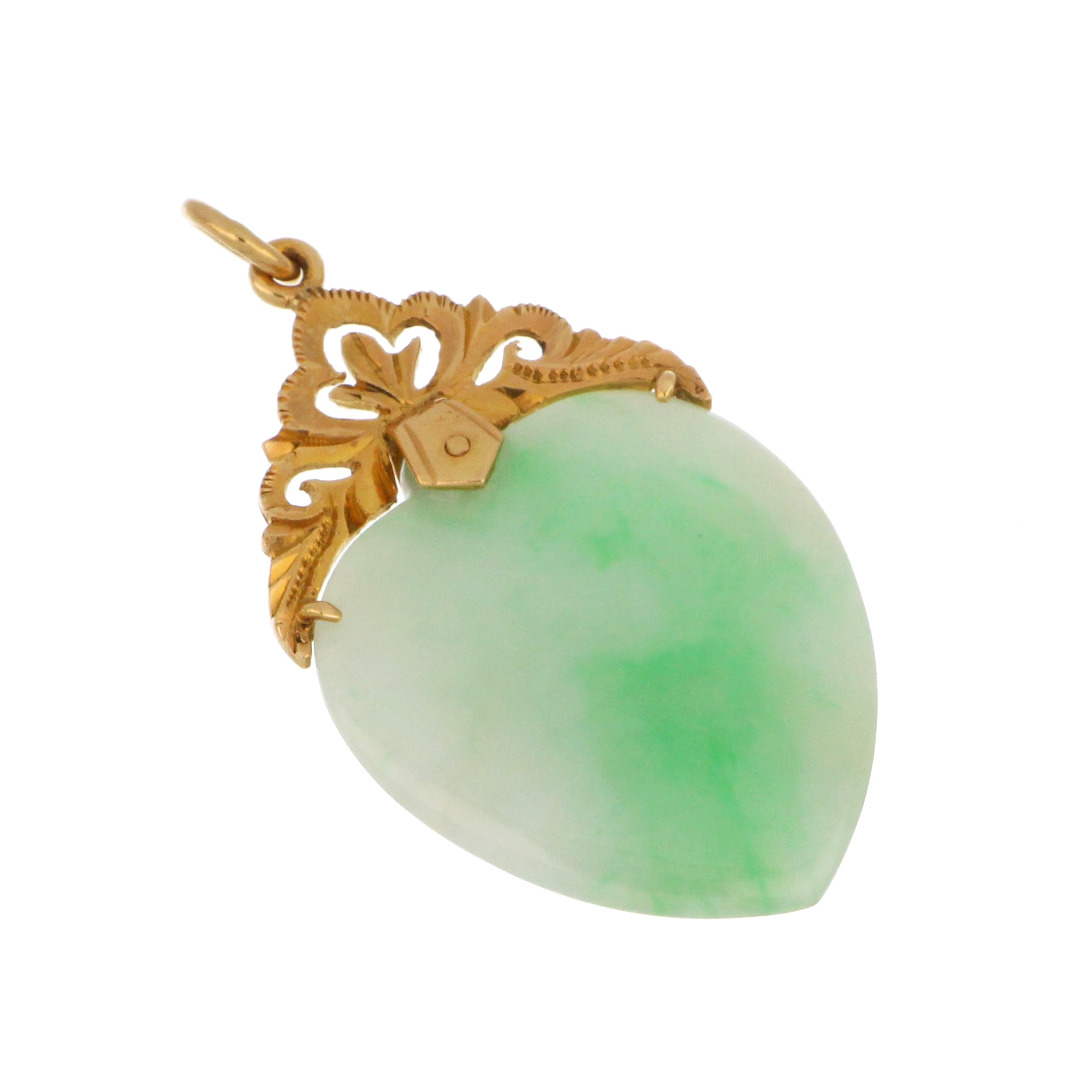 Close-up of 18kt yellow gold pendant with heart-shaped jadeite jade showcasing subtle yellow spots and polished finish