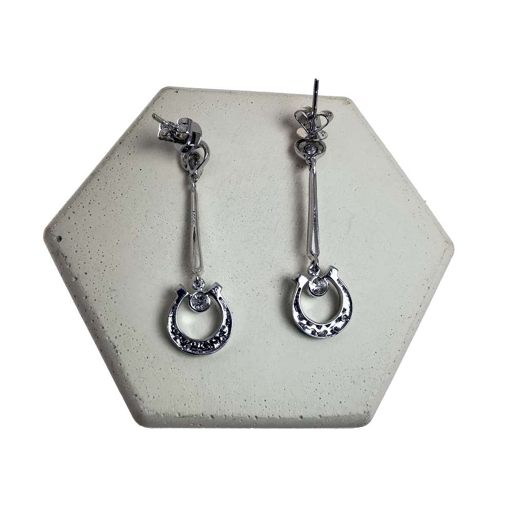 Side angle of 14kt white gold dangle earring showing elegant design and diamond setting
