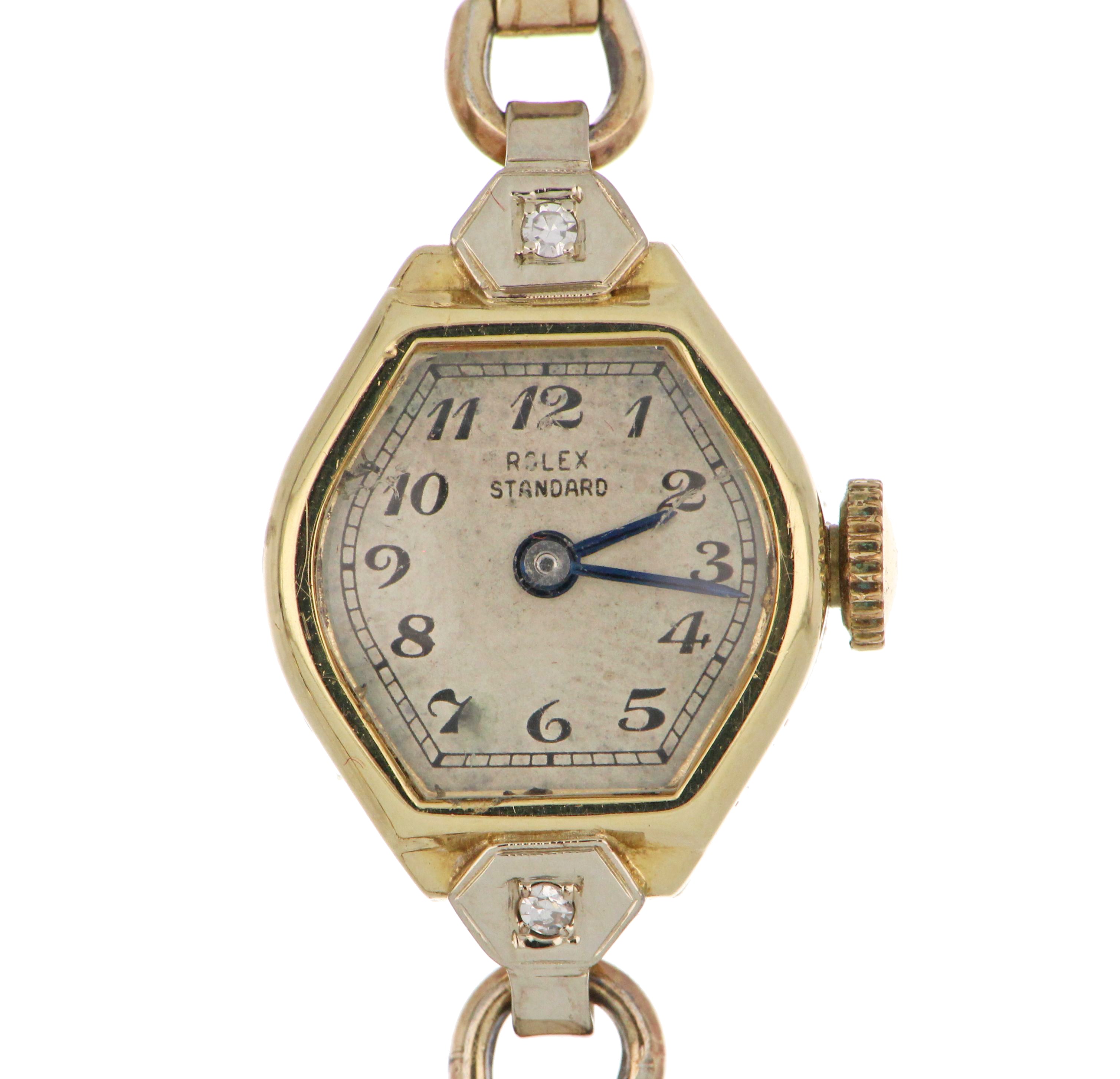 Close-up of ladies' Rolex wristwatch showcasing 14kt yellow gold case with two single-cut diamonds and silver dial