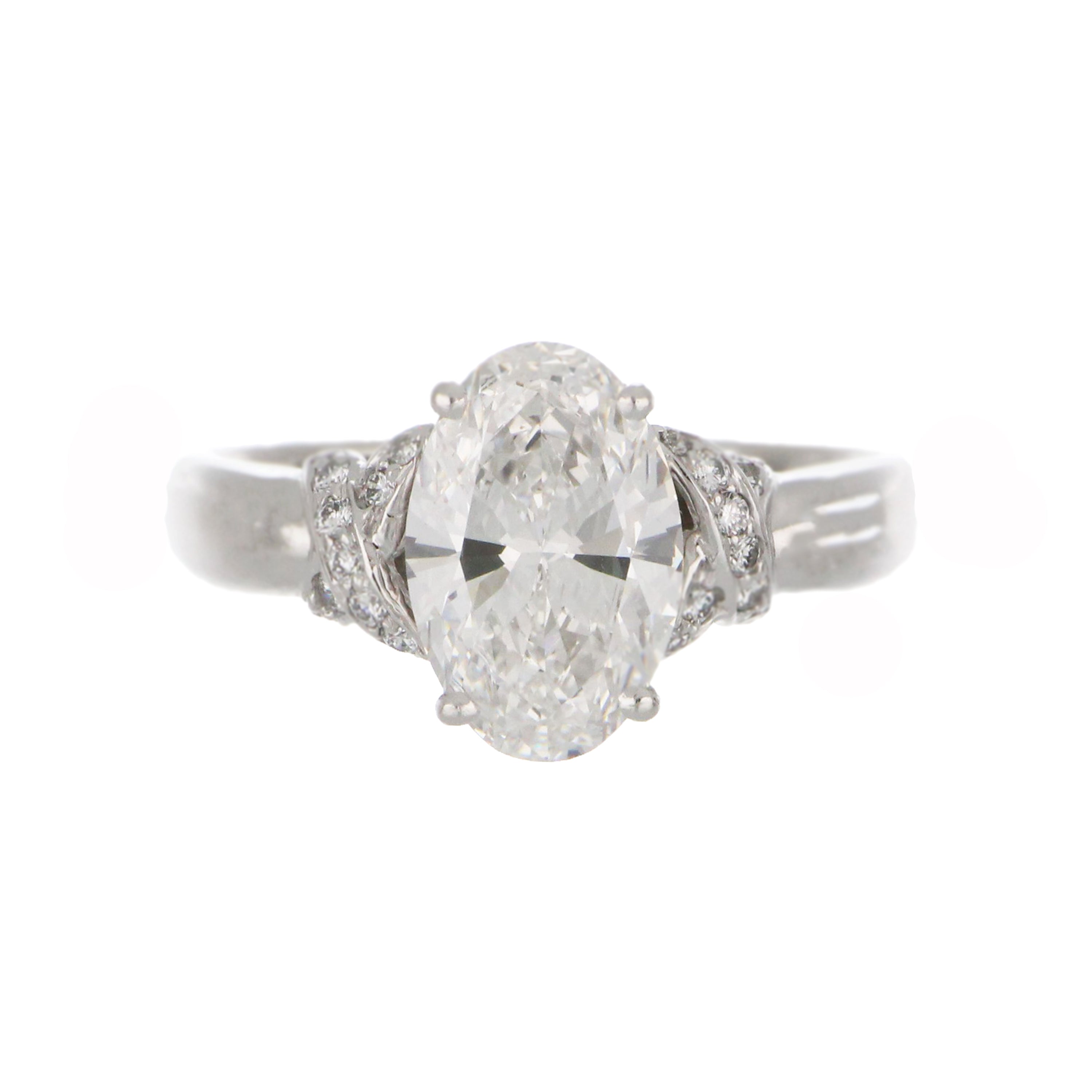 18kt white gold diamond ring showcasing oval brilliant diamond center stone viewed from top angle