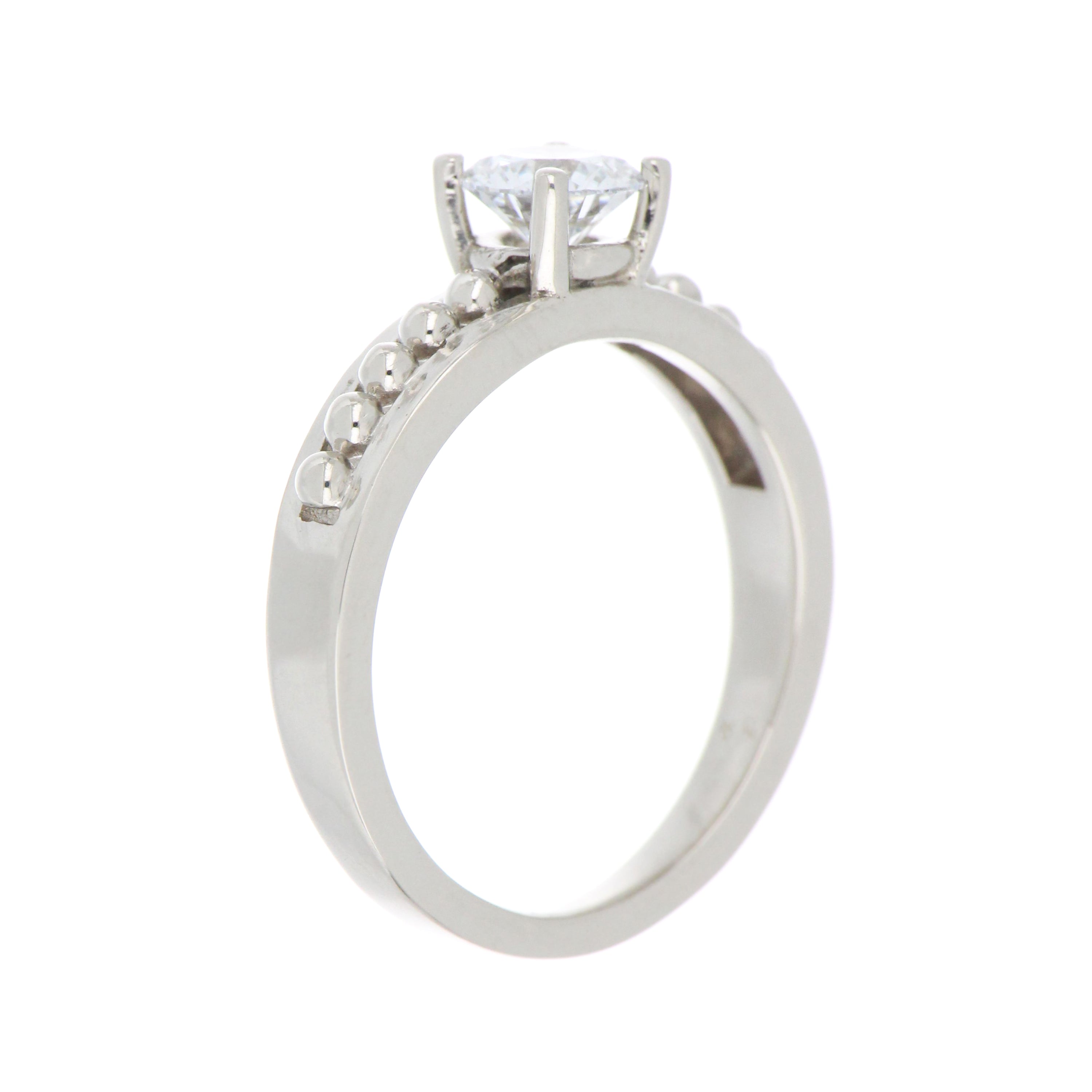 Close-up of brilliant round lab grown diamond set in claw setting on 14kt white gold ring