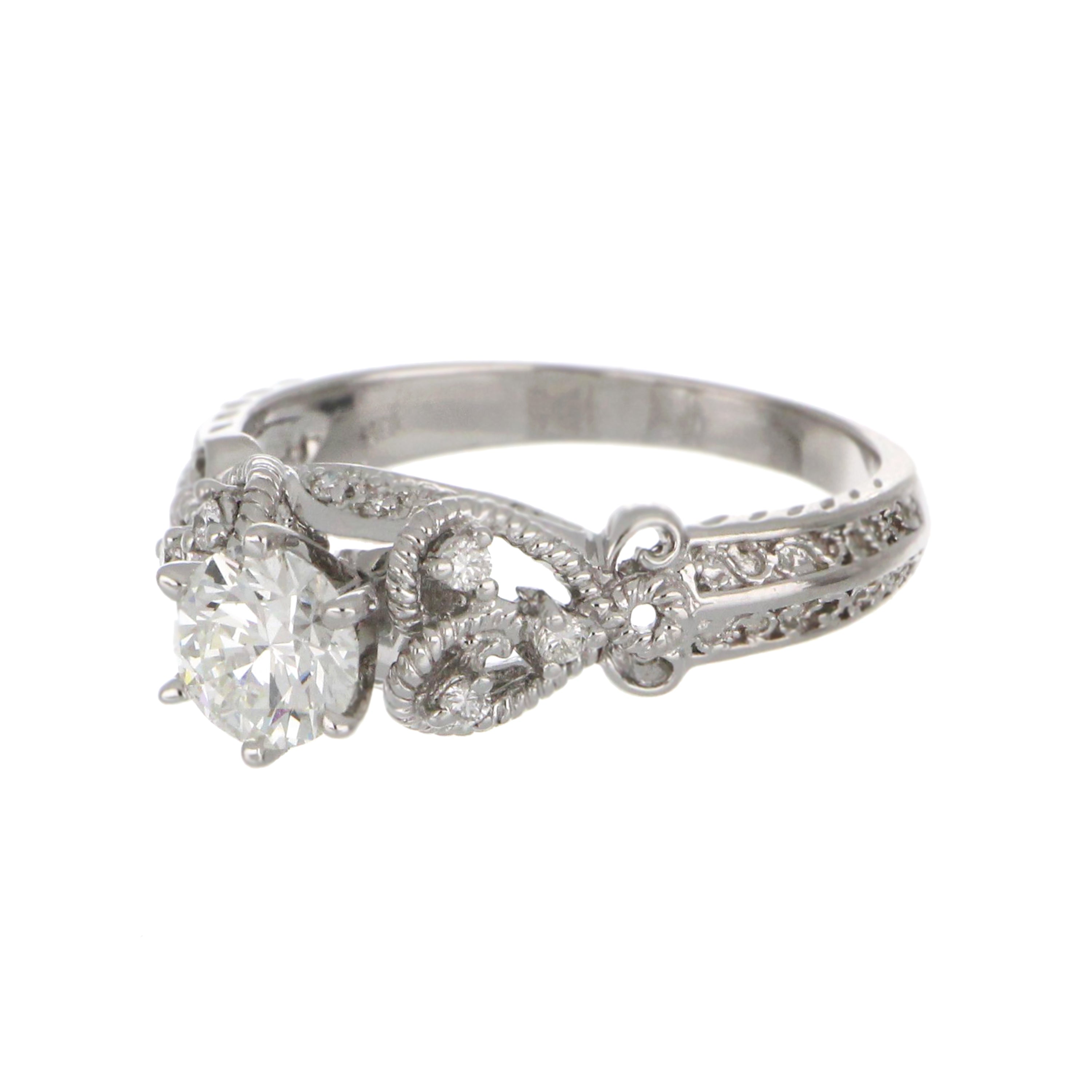 Elegant 18kt white gold engagement ring with round brilliant diamonds against black background