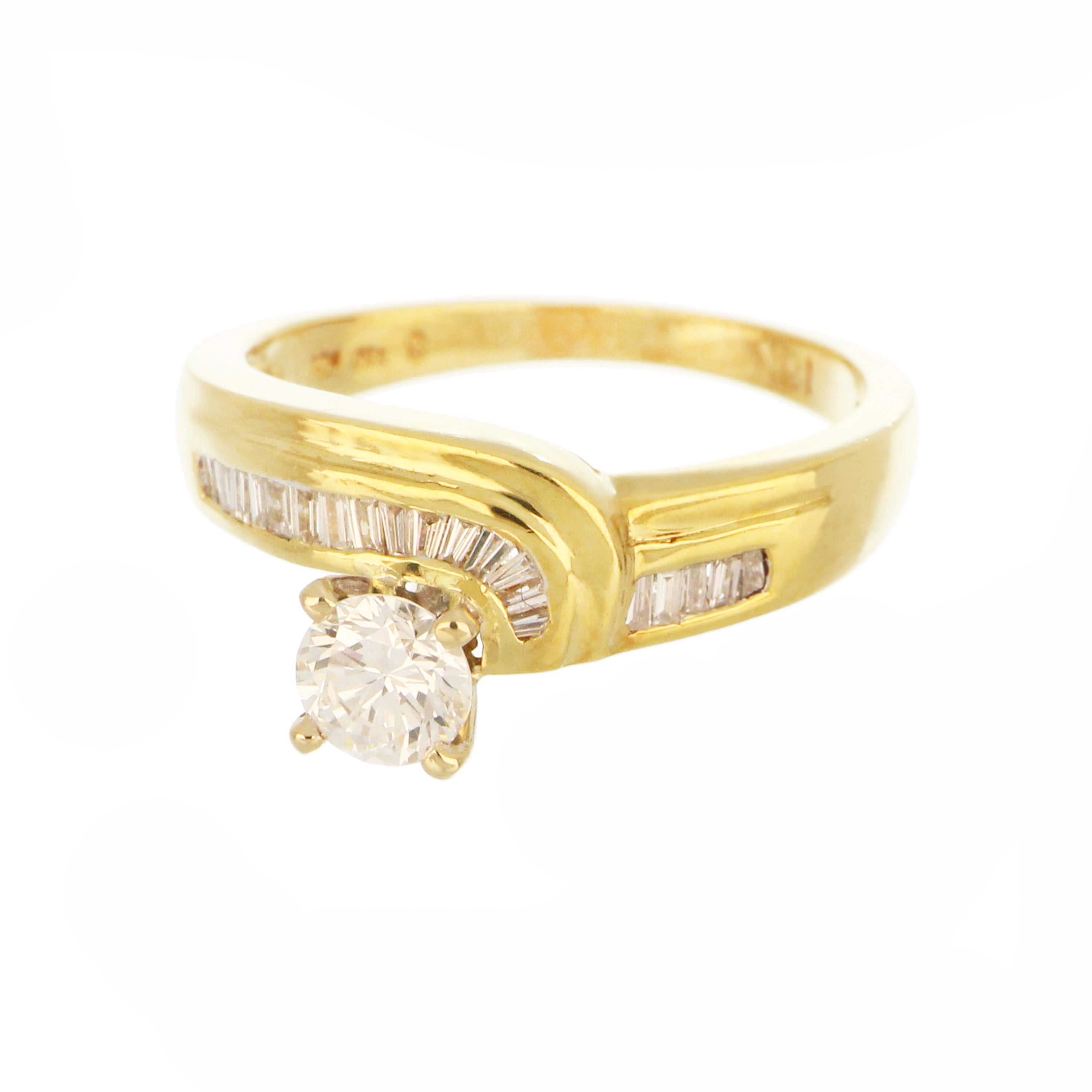 Side profile of 18kt yellow gold engagement ring with 0.53ct round diamond and baguette diamond accents in claw and channel settings