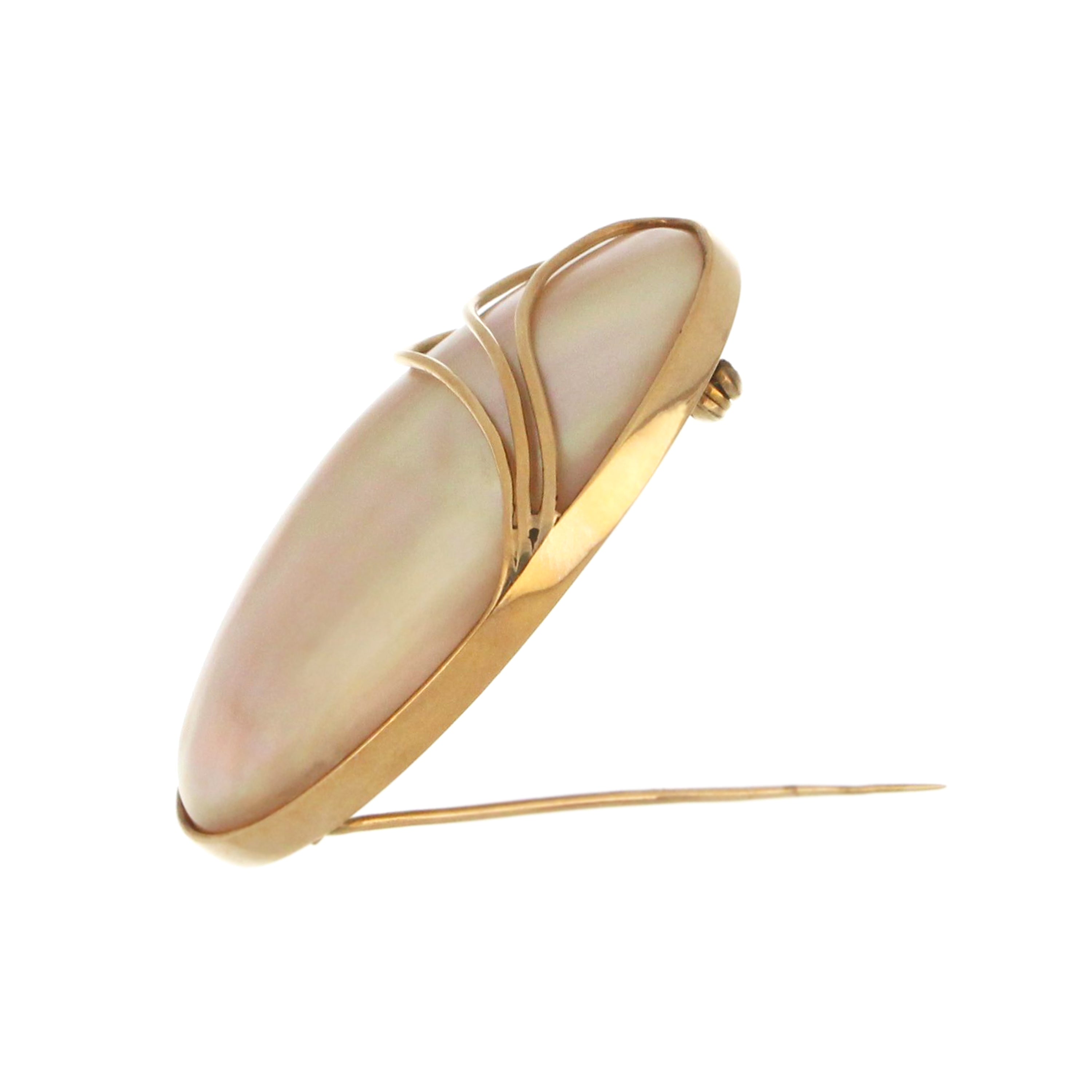 Side view of 10kt yellow gold pendant brooch showing thickness and full bezel setting of white mother-of-pearl