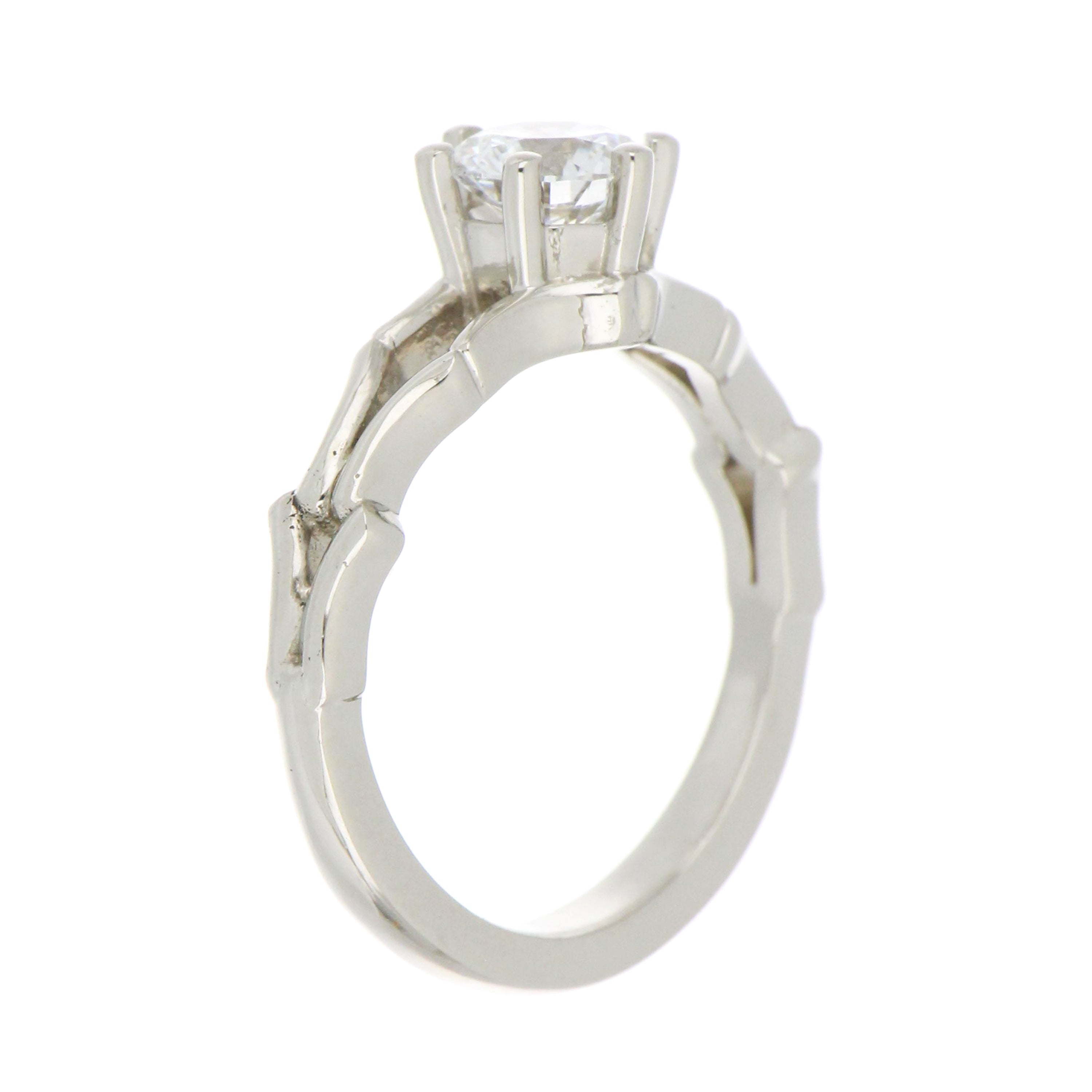 Top view of 14kt white gold ring with 0.83ct lab grown round diamond, highlighting polished shank and claw setting