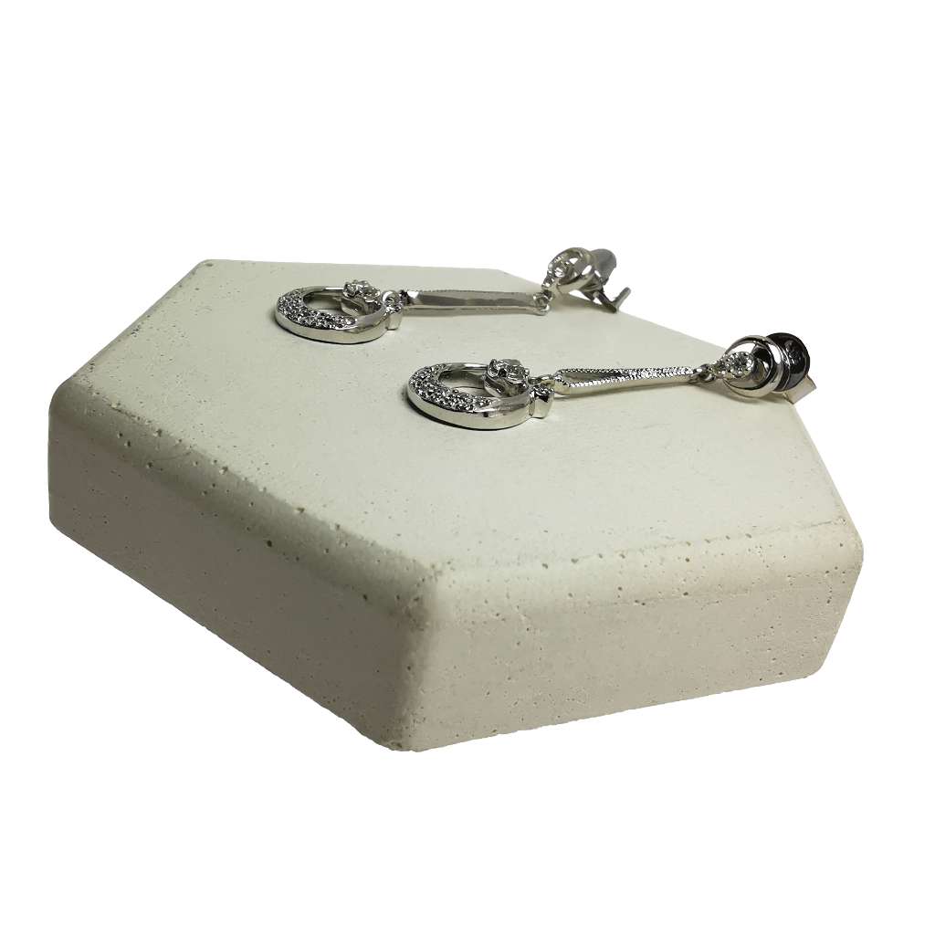 Close-up of 14kt white gold dangle diamond earrings highlighting clarity and craftsmanship