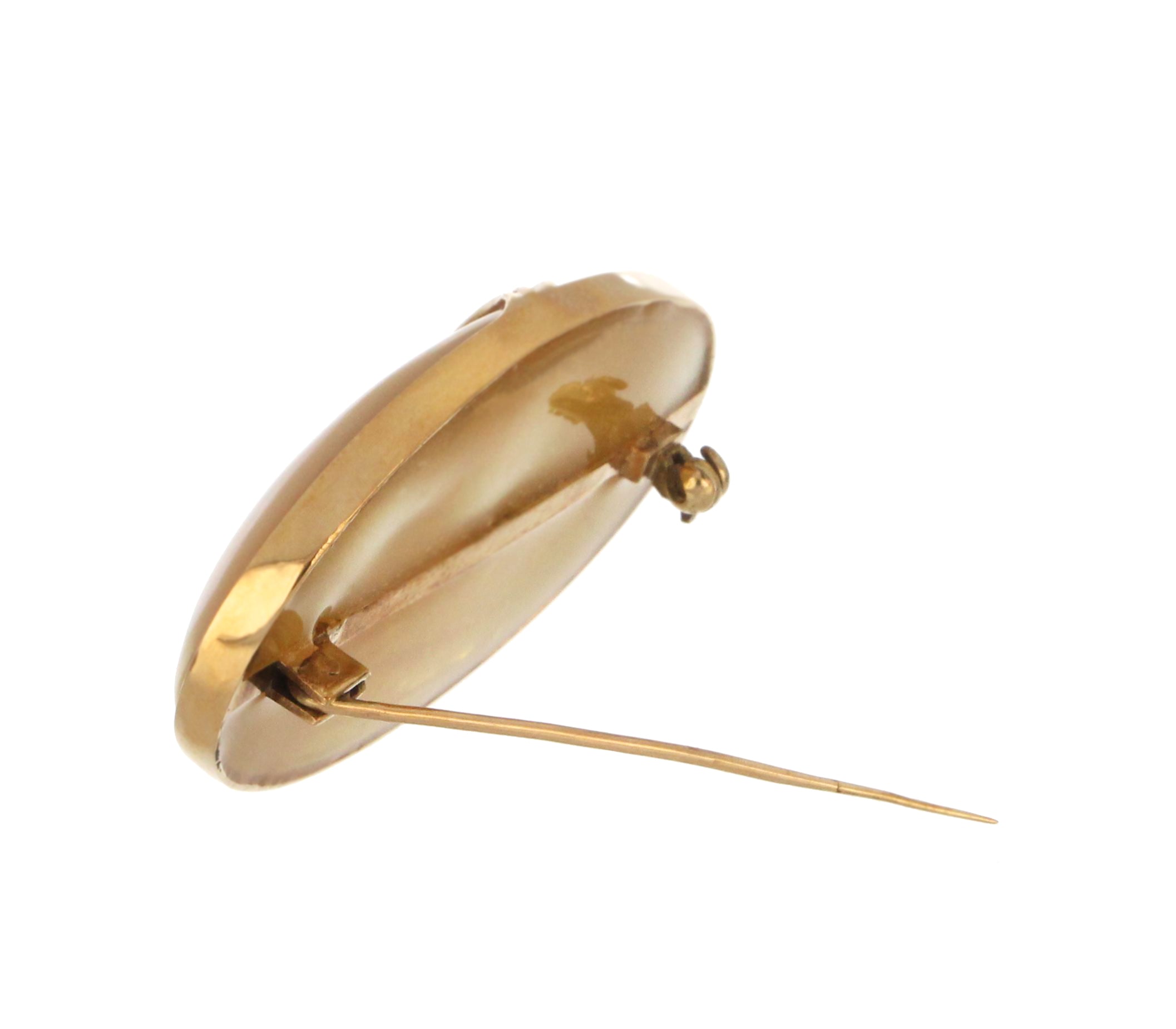 Close-up of white mother-of-pearl in 10kt yellow gold pendant, highlighting smooth bezel and lustrous surface