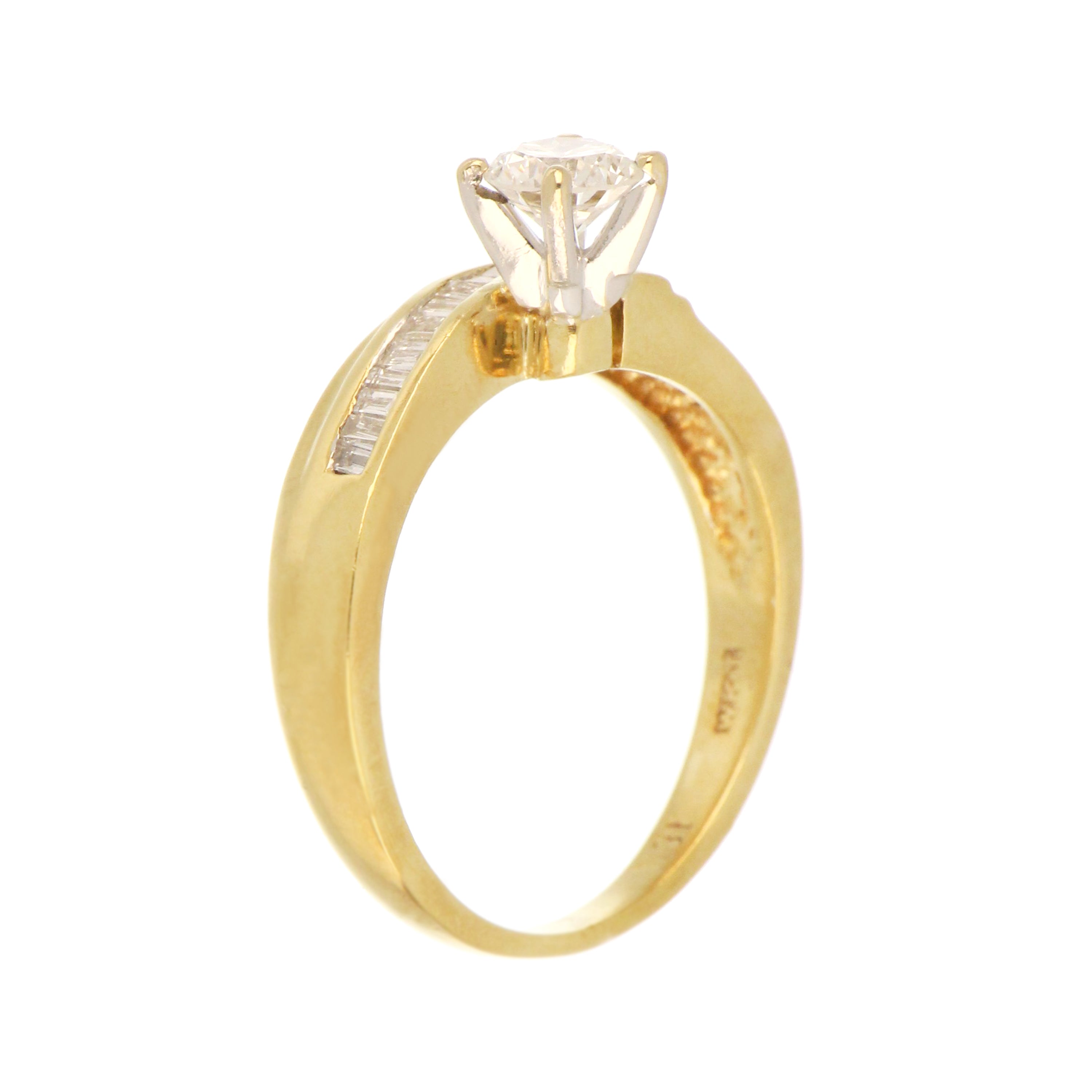 Top view of 18kt yellow gold diamond ring displaying intricate diamond setting and polished finish