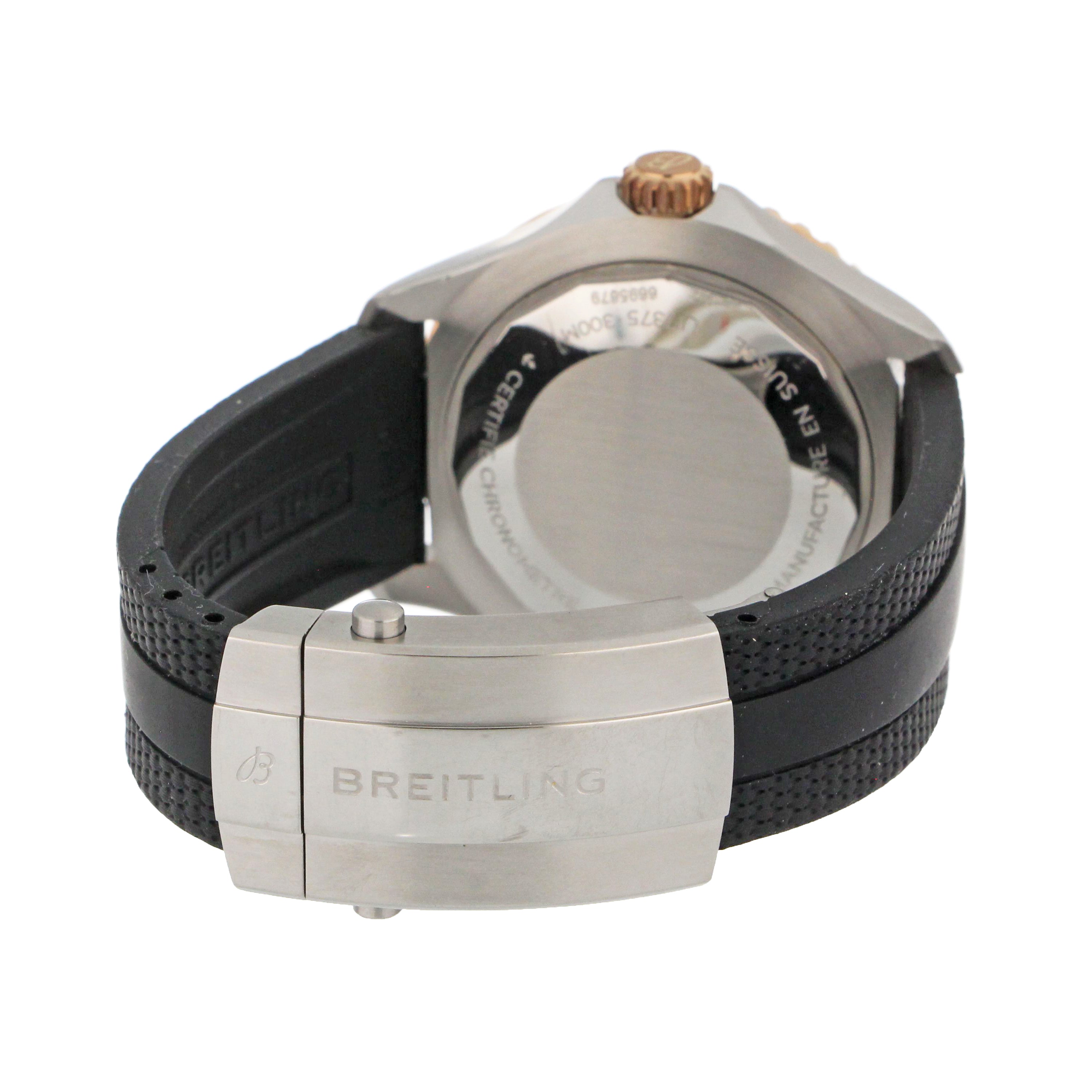 Angled shot of Breitling SuperOcean watch emphasizing rose gold bezel and black rubber strap.
