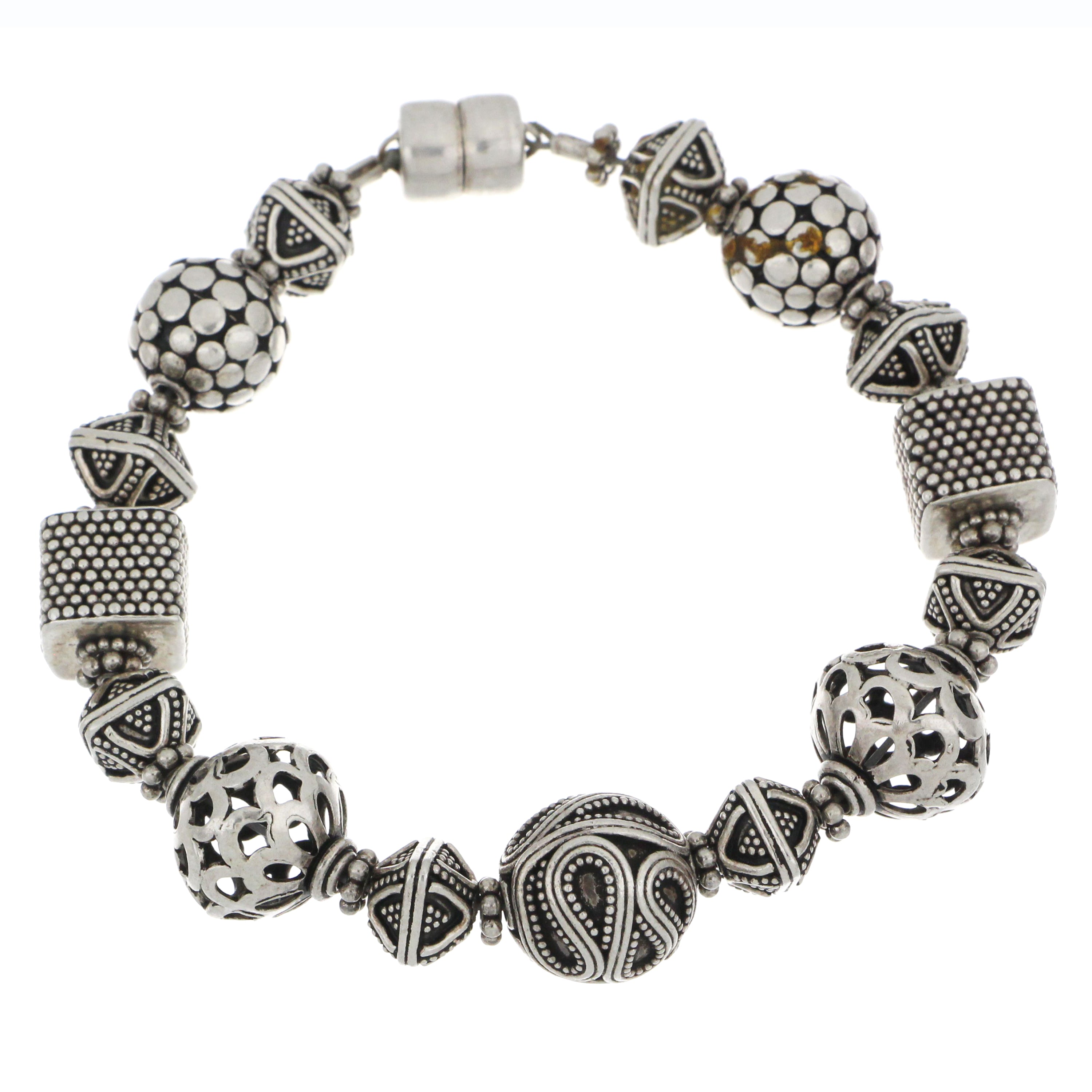 Handcrafted silver bracelet featuring mixed bead designs with filigree and textured detailing.