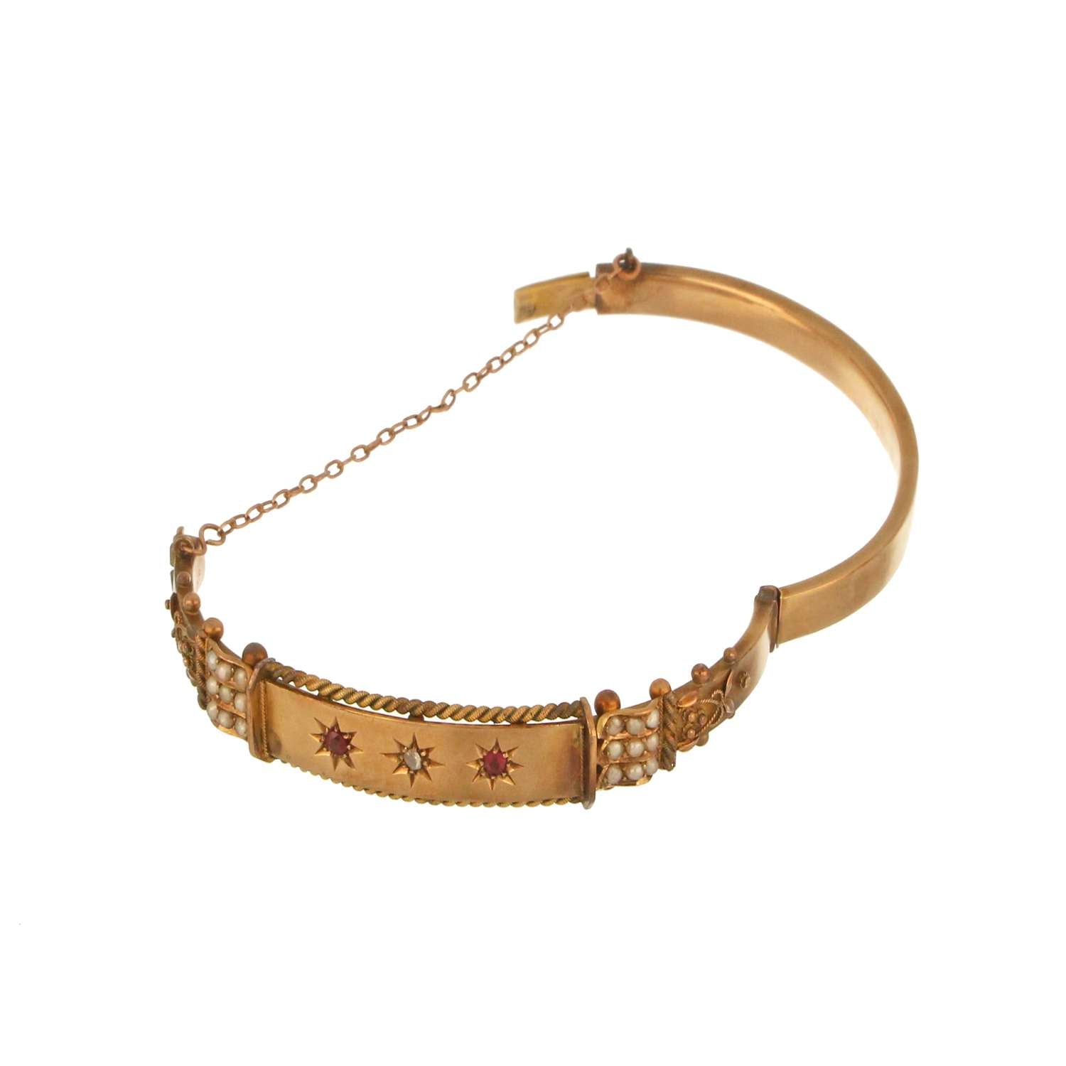 Elegant 9kt antique bangle bracelet featuring rubies, rose-cut diamond, and seed pearls