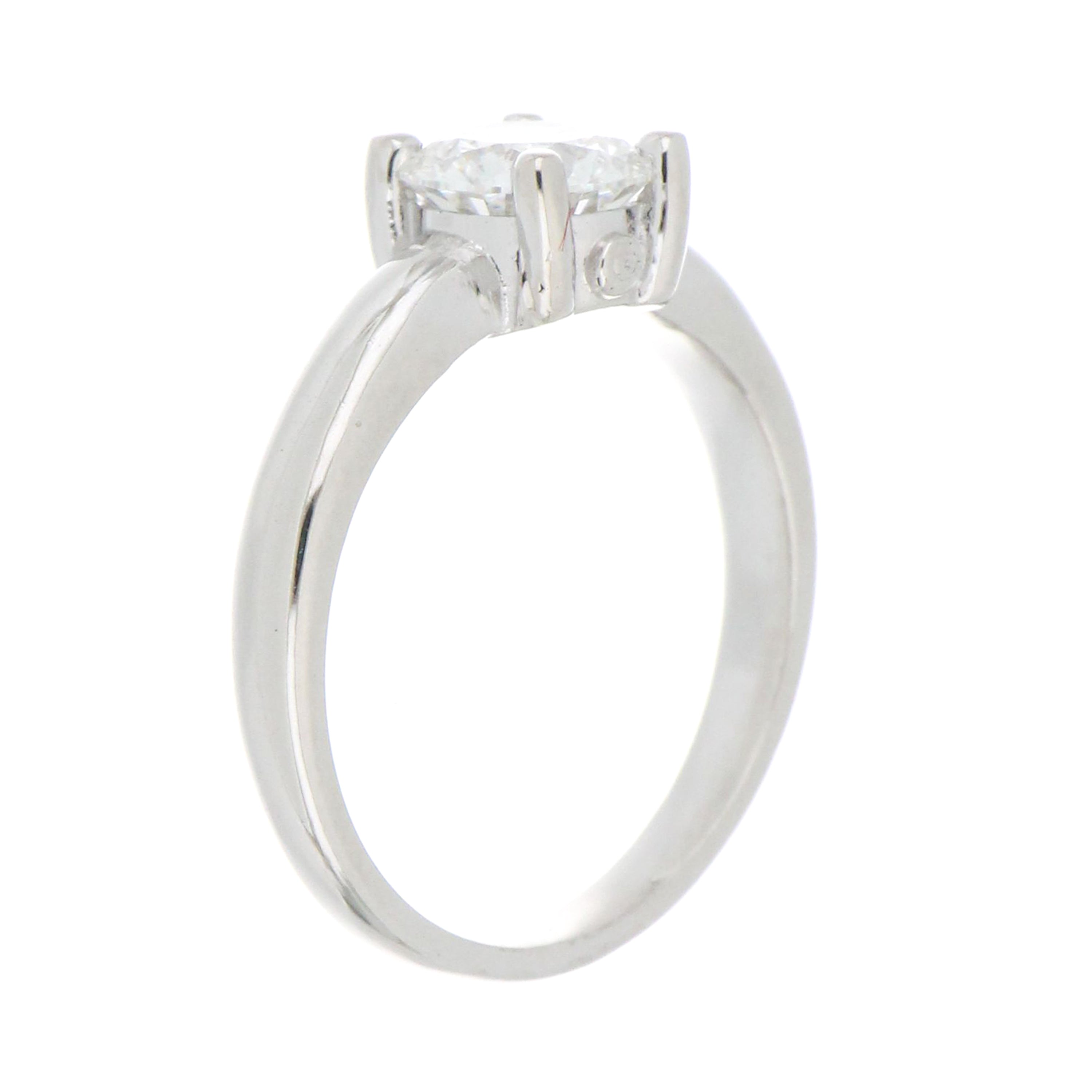 Side profile of 14kt white gold solitaire diamond ring highlighting the claw setting and slim polished shank design