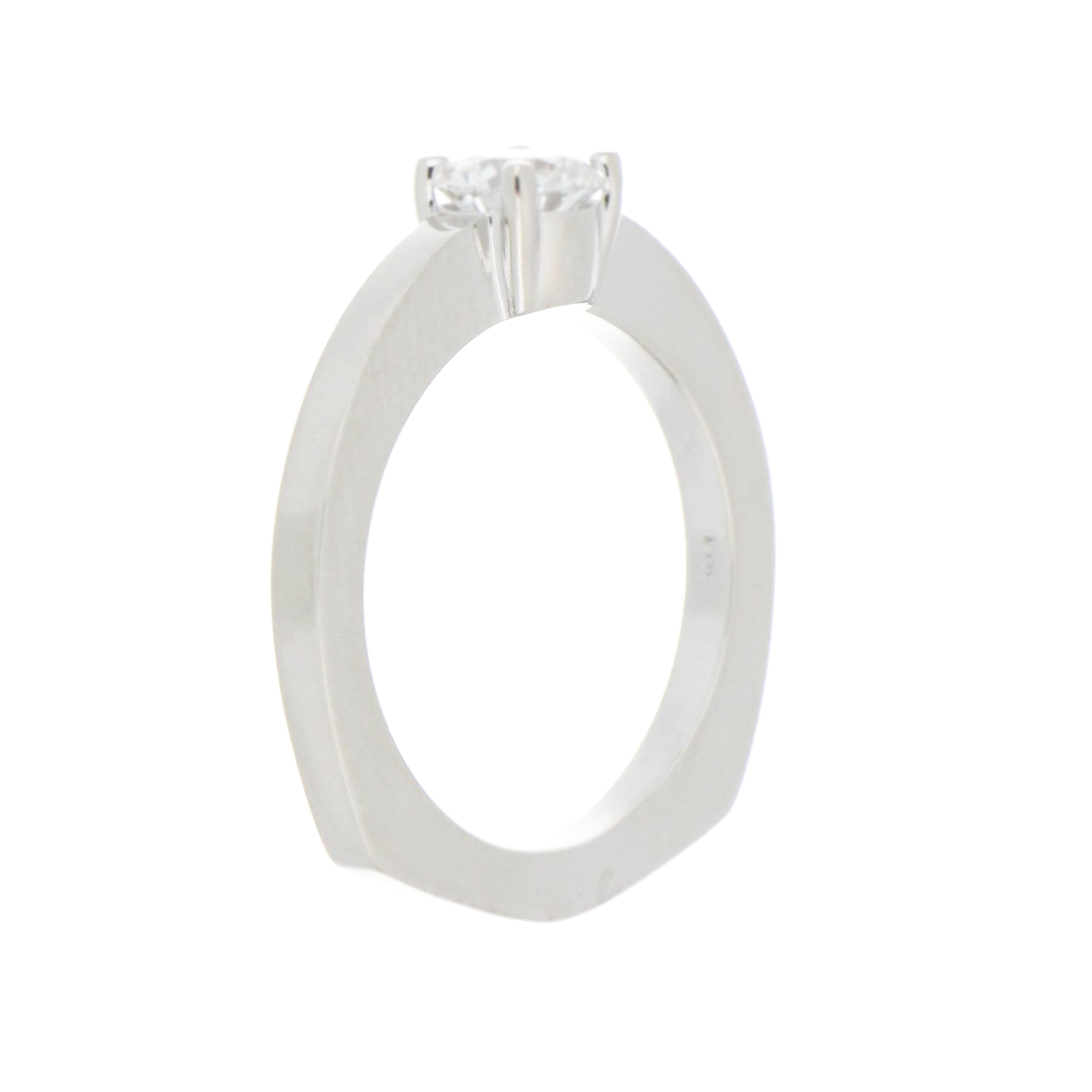 Side profile of 14kt white gold solitaire diamond ring showcasing claw prongs and flat edge shank design