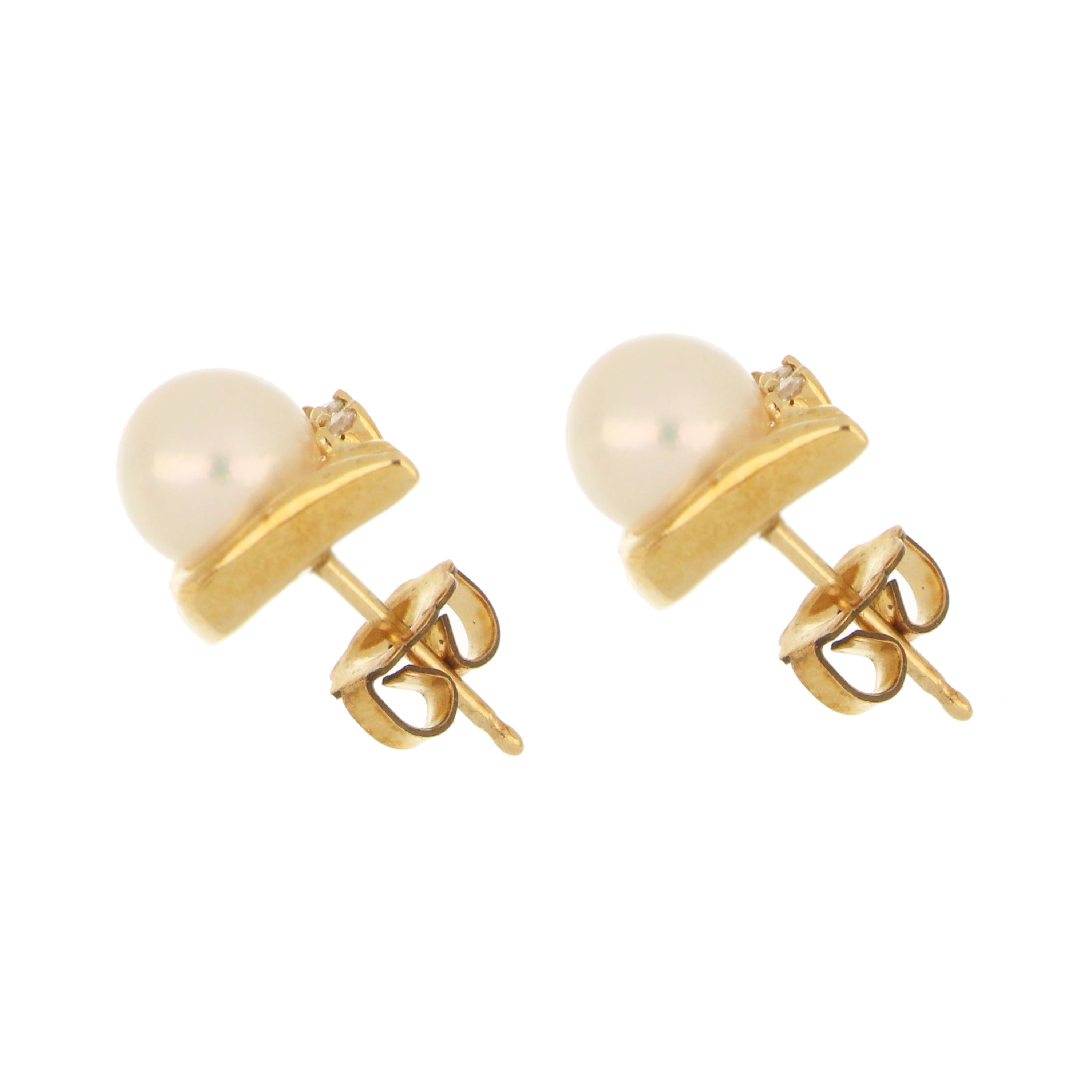 Classic pearl and diamond stud earrings set in 10kt yellow gold with push-back closure.