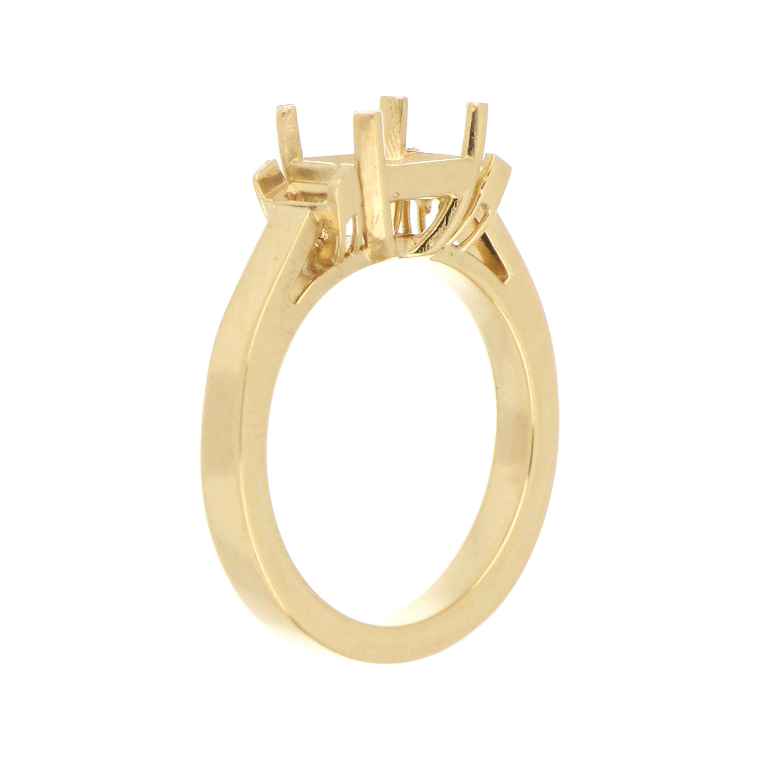 Custom 14k yellow gold mounting for emerald cut center and side accent stones.
