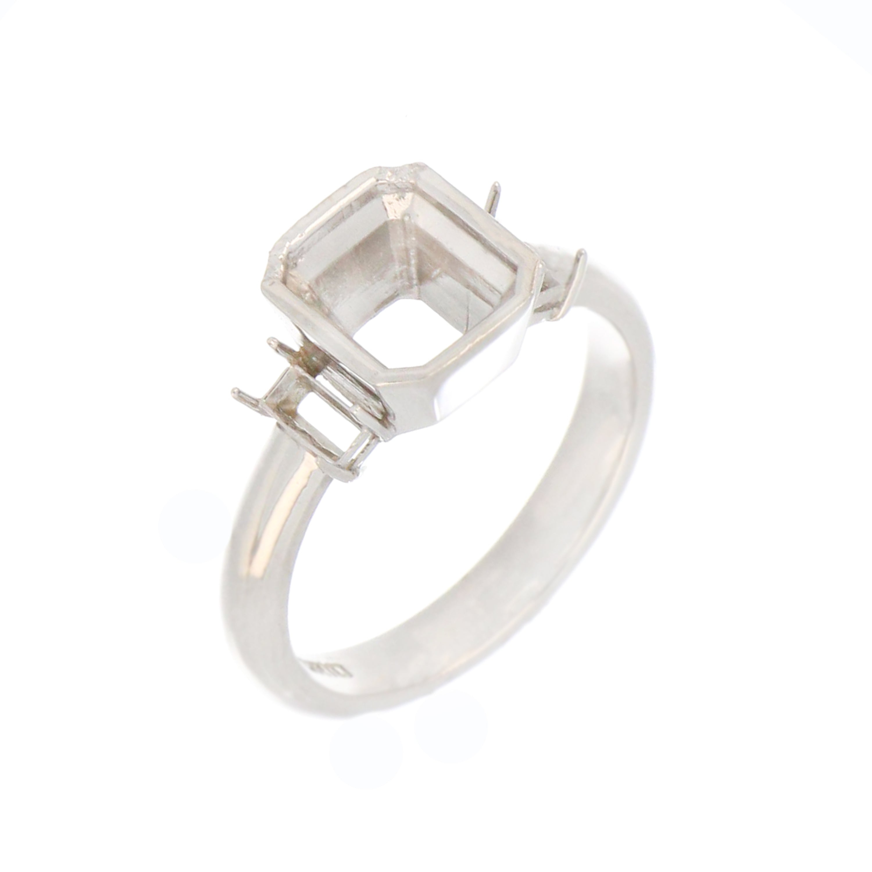 Close-up of claw-set rectangular side stone mounts on white gold ring