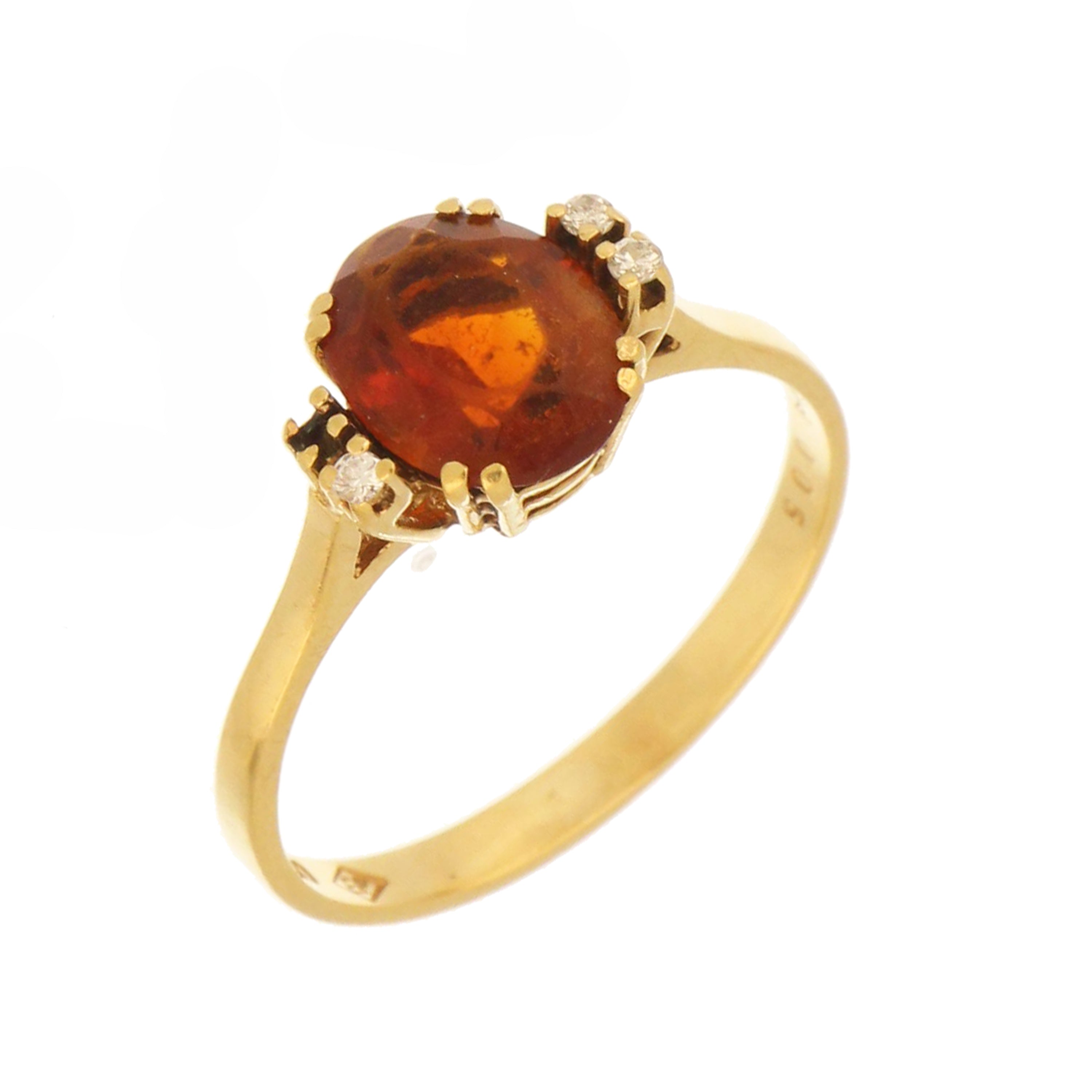 Side view of garnet ring showing gold prong setting and diamonds