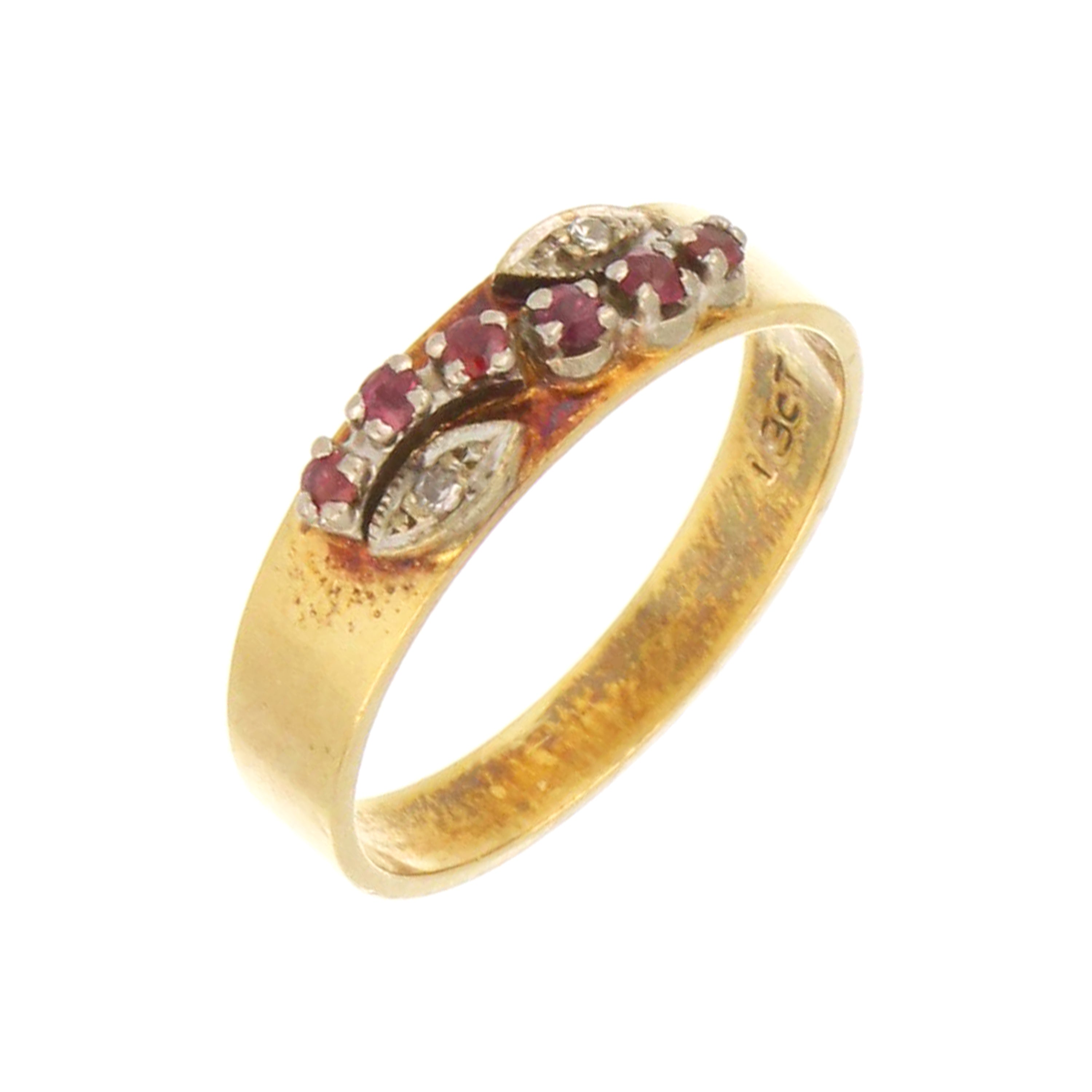 close-up of ruby and diamond gold ring with curved design
