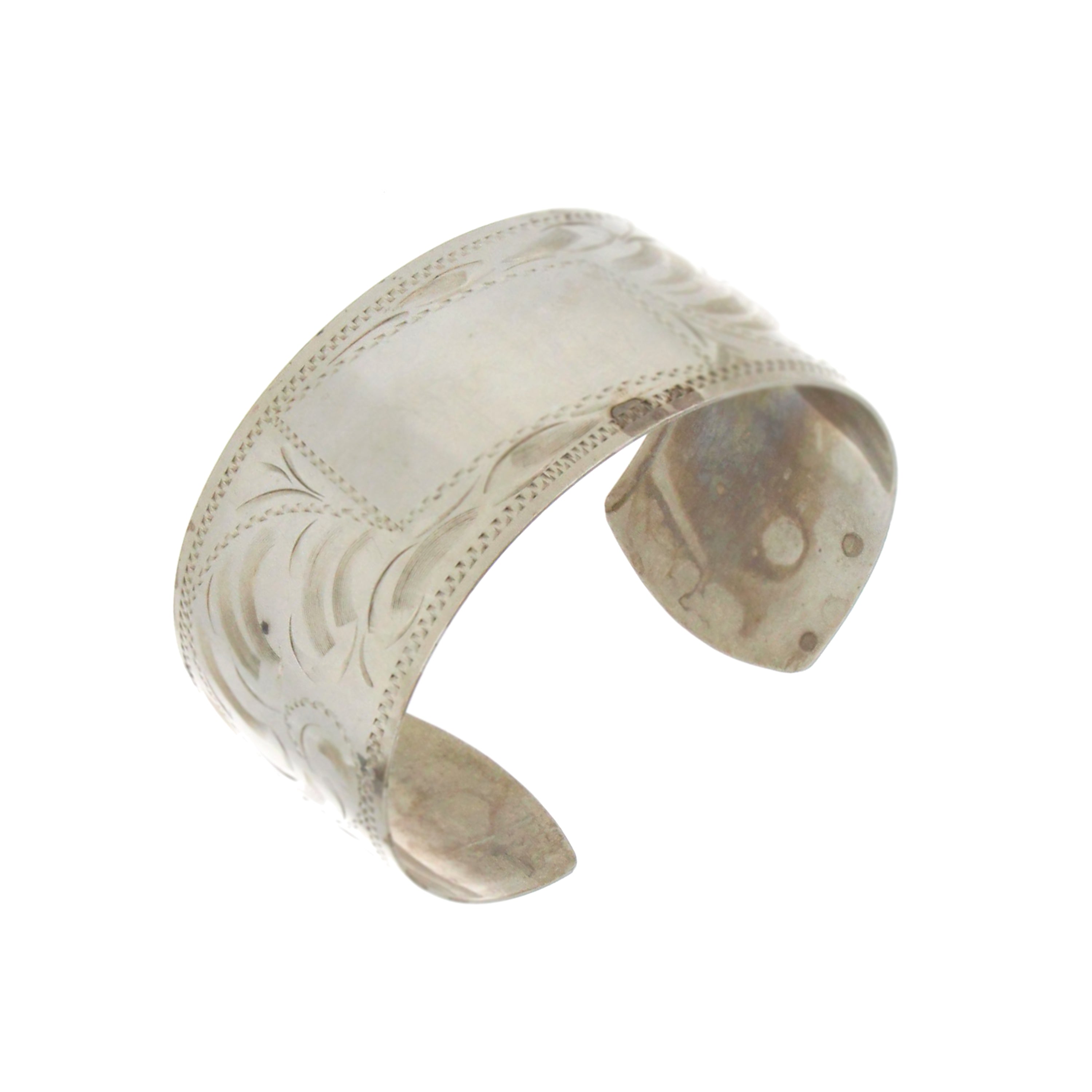 Sterling silver open-back bangle, 1.25-inch wide cuff with engraved detail, 29.64 grams.