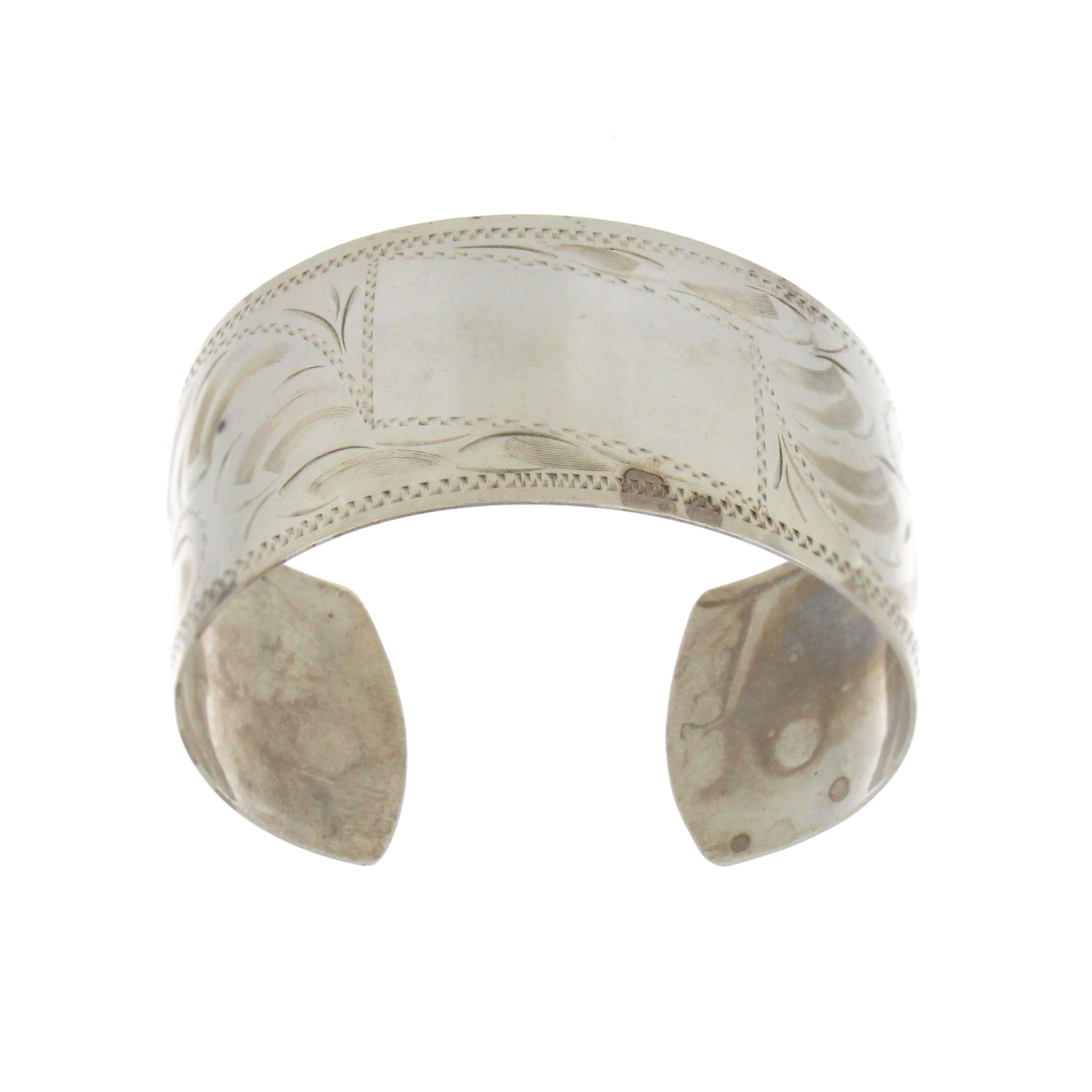 Vintage sterling silver cuff bracelet with open back and classic etched design.