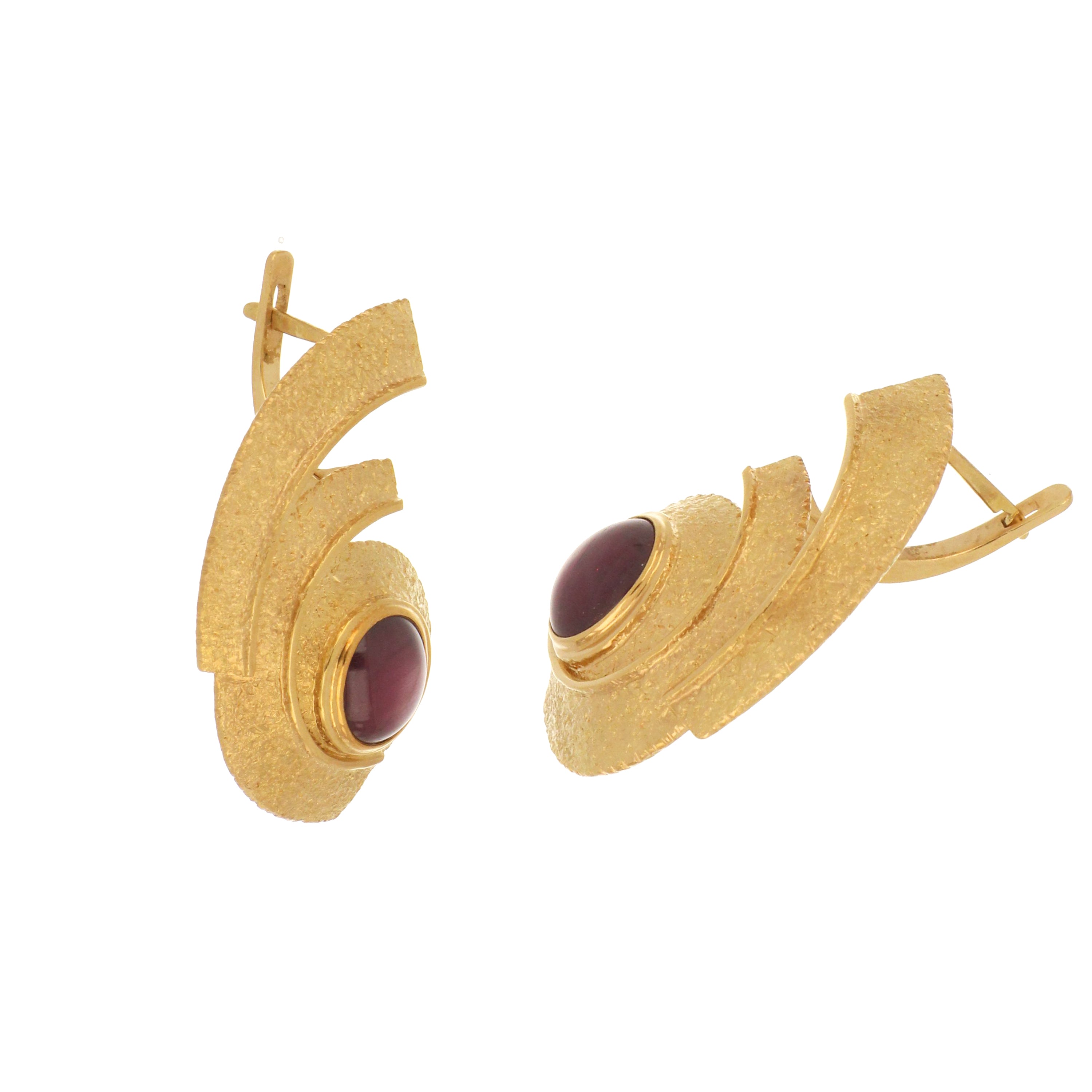 Vintage-style gold swirl earrings with rare cabochon star rubies set in 18kt yellow gold.